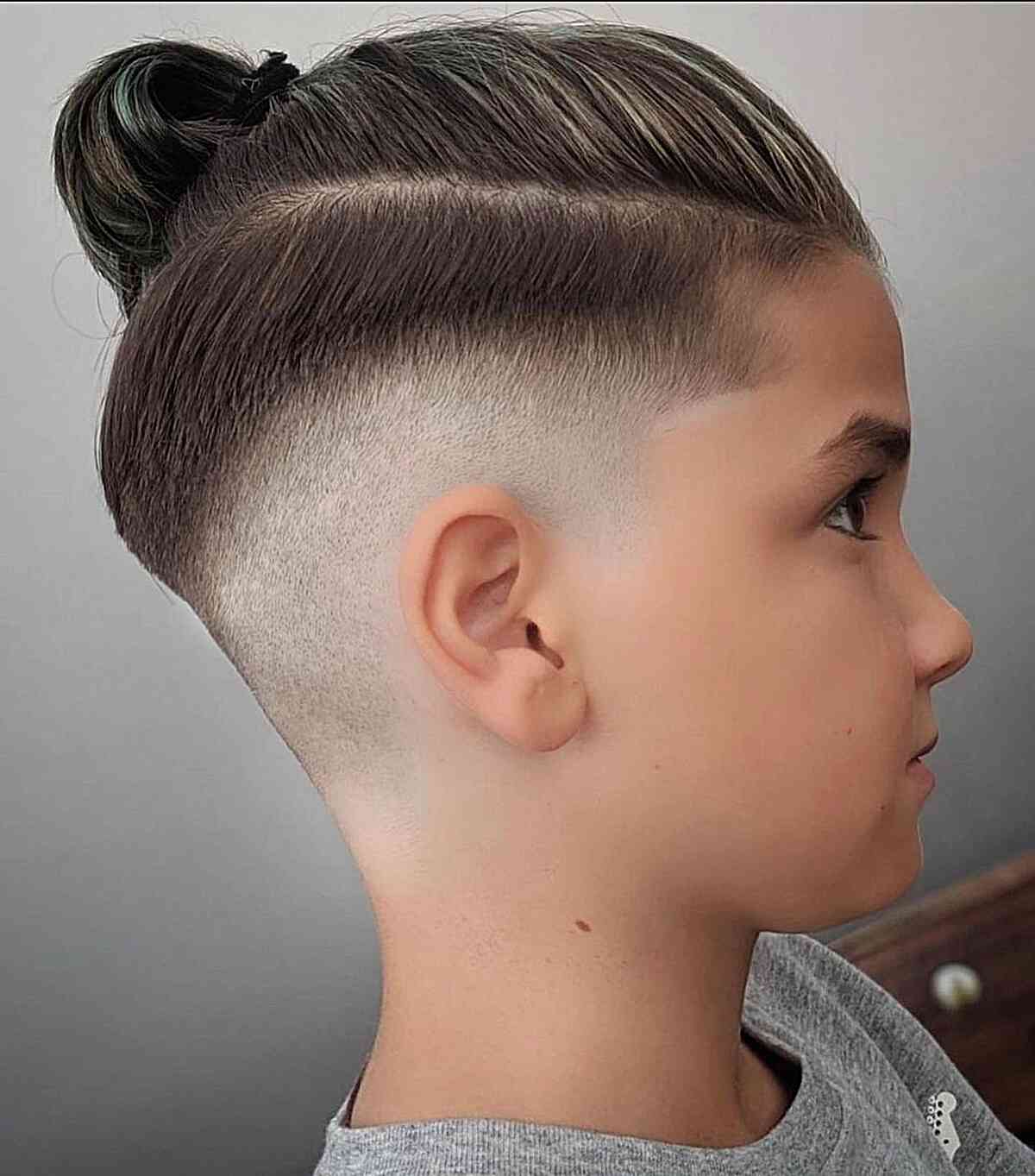 Mid Fade Paired with a Man Bun for Boys