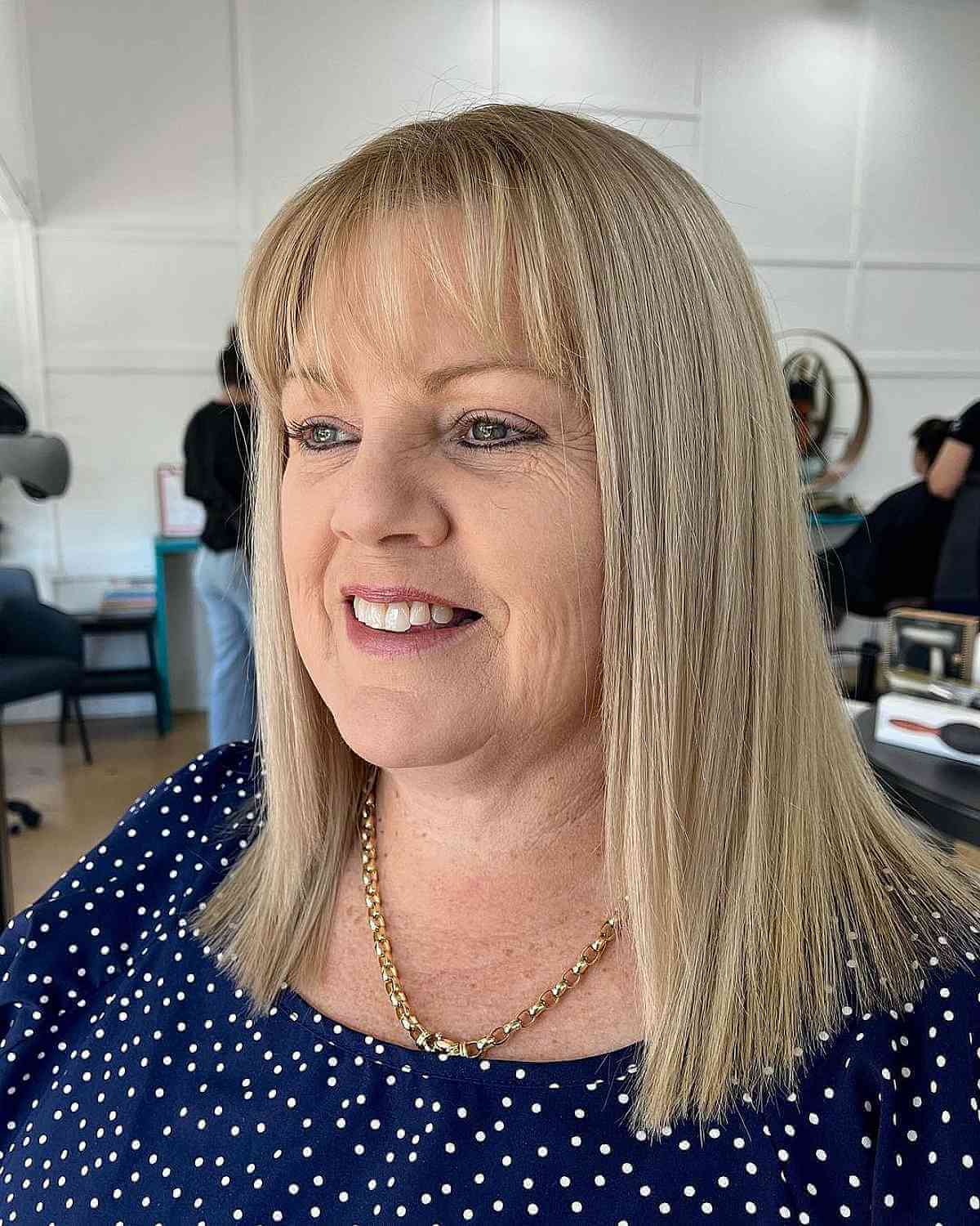 Mid-Length Blonde Hairstyle with Soft Fringe