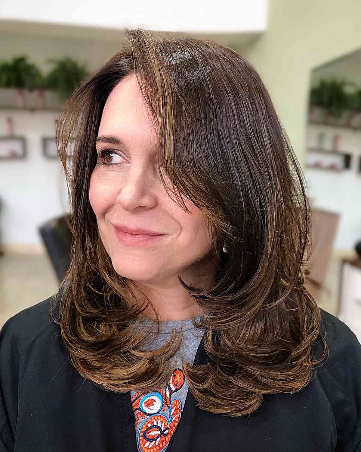 Mid-Length Butterfly Layered Cut Featuring Long Bangs for Mature Women