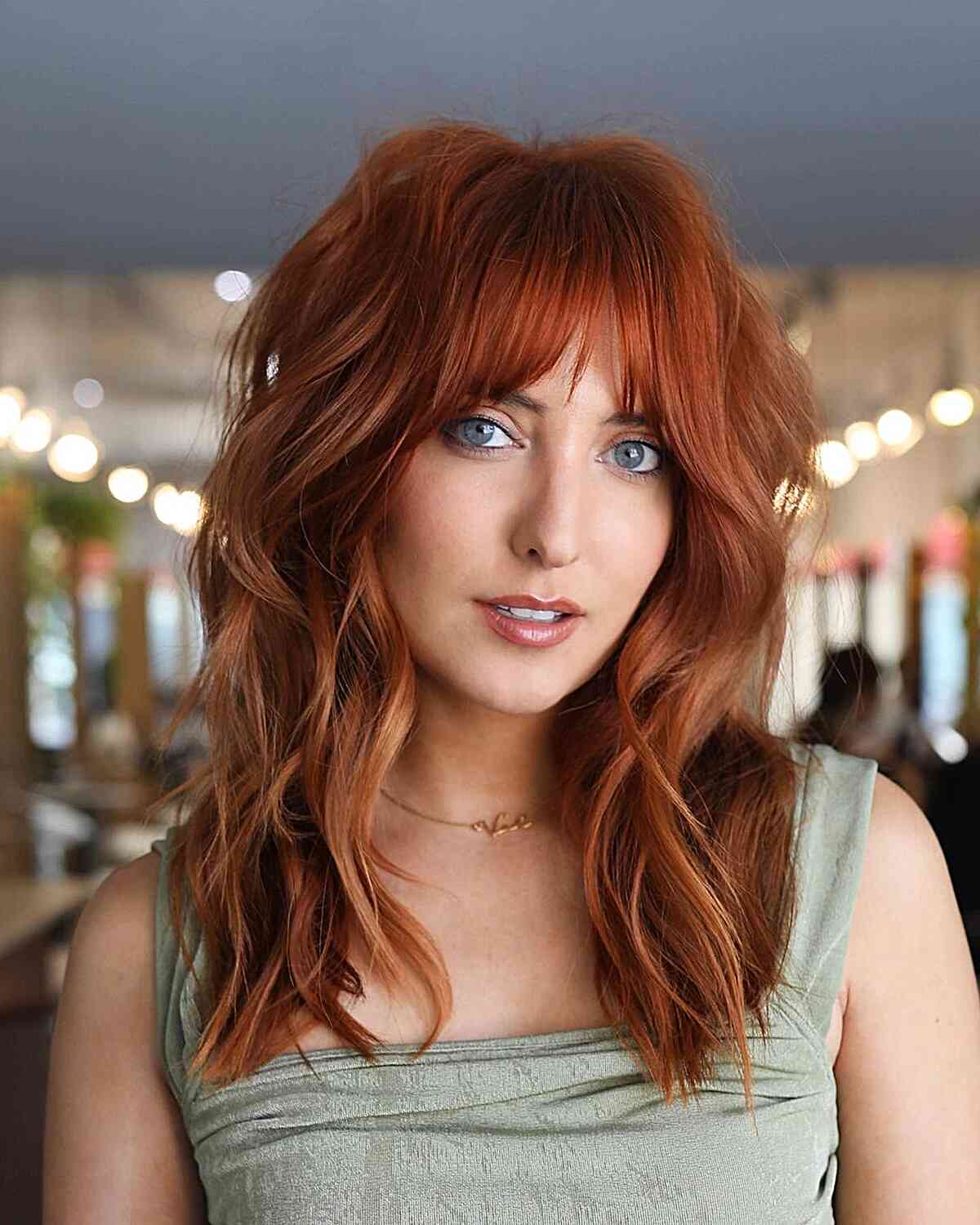 Stylish Copper Layers for Mid-Length Hair with Bangs suitable for those with longer faces