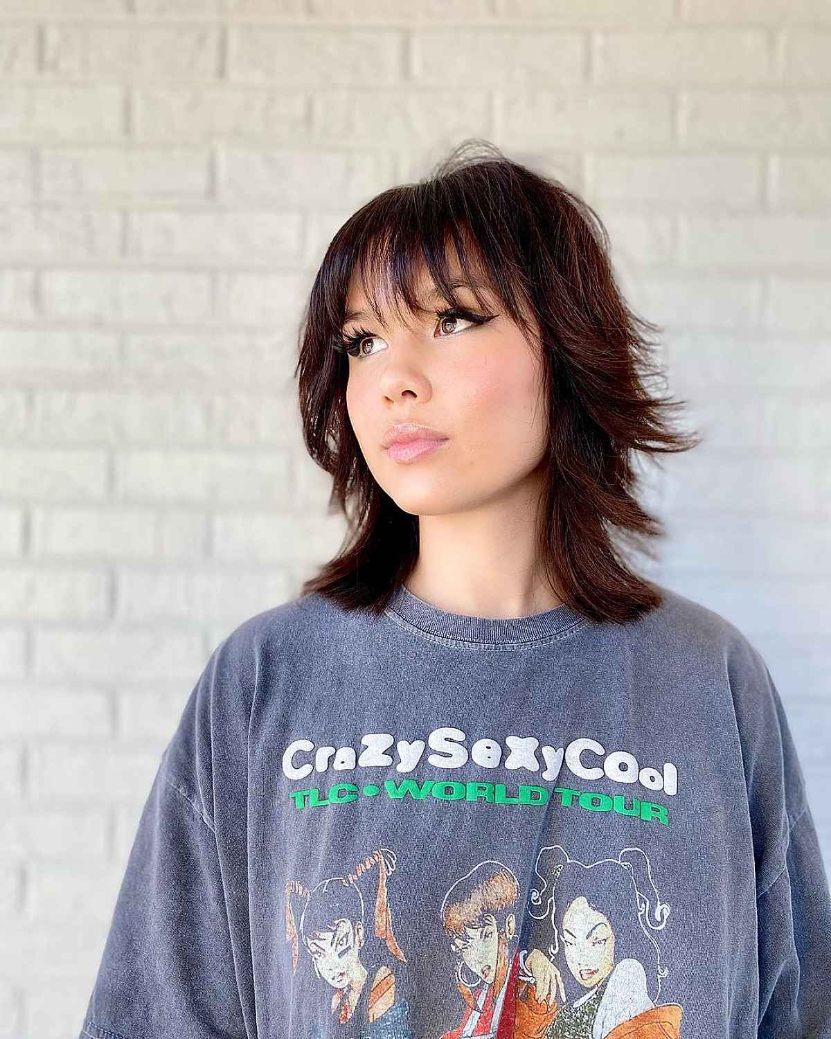 Mid-Length Haircut with Bangs and Feathered Layers