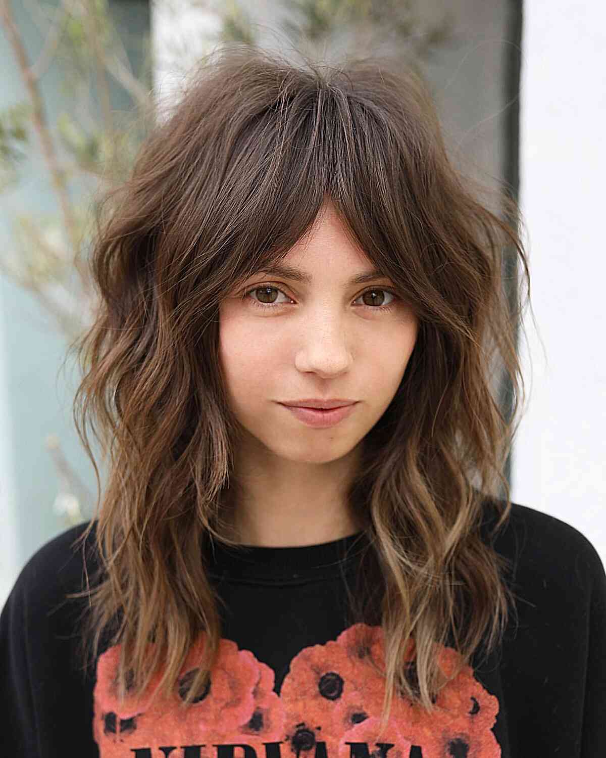 Mid-Length Shag Haircut for Voluminous Hair with Curtain Bangs for women with layered messy hairstyles