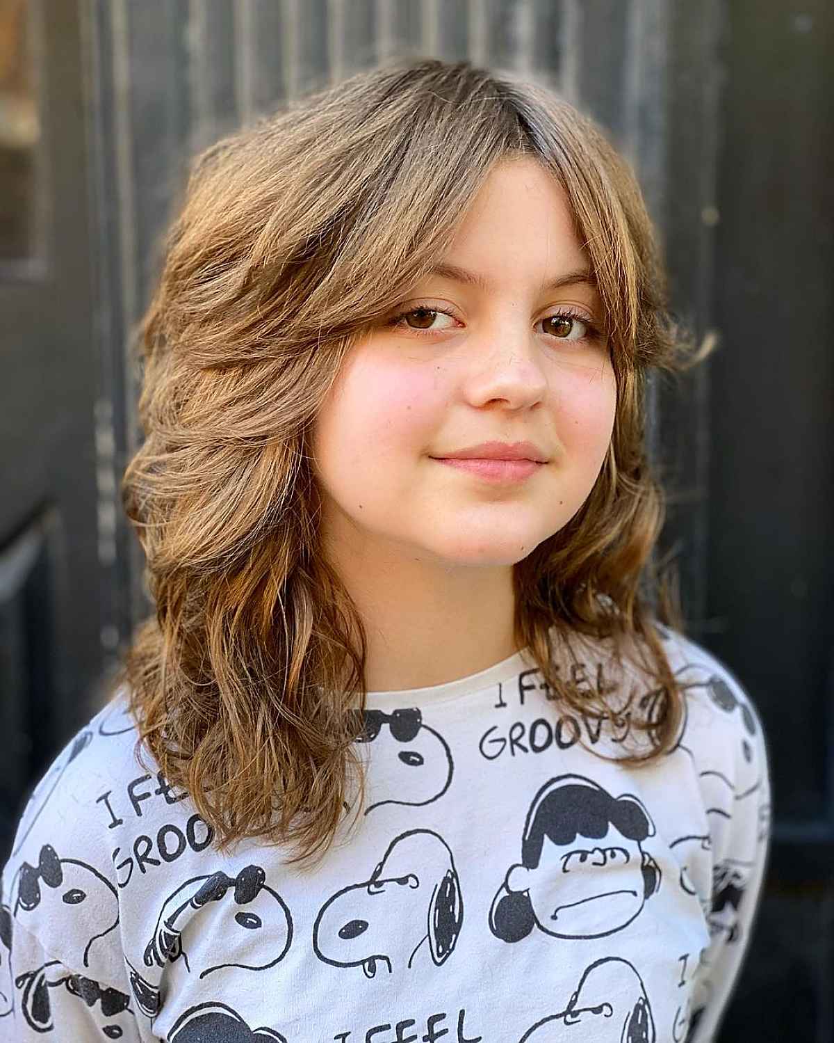 mid-length to long layered hairstyle with gentle wavy curls