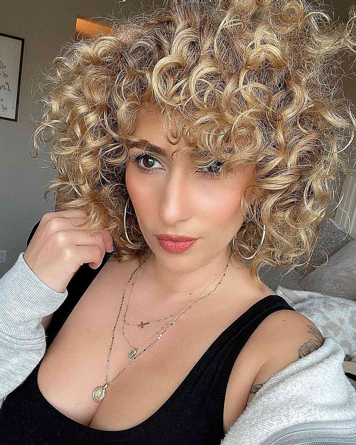 Neck-Length Textured Blonde Curly Hair and Curly Bangs with Layers