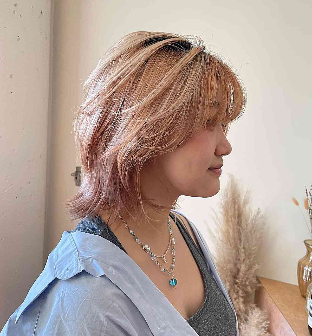 Short Peach Blonde Tresses with Butterfly Layers and Bangs