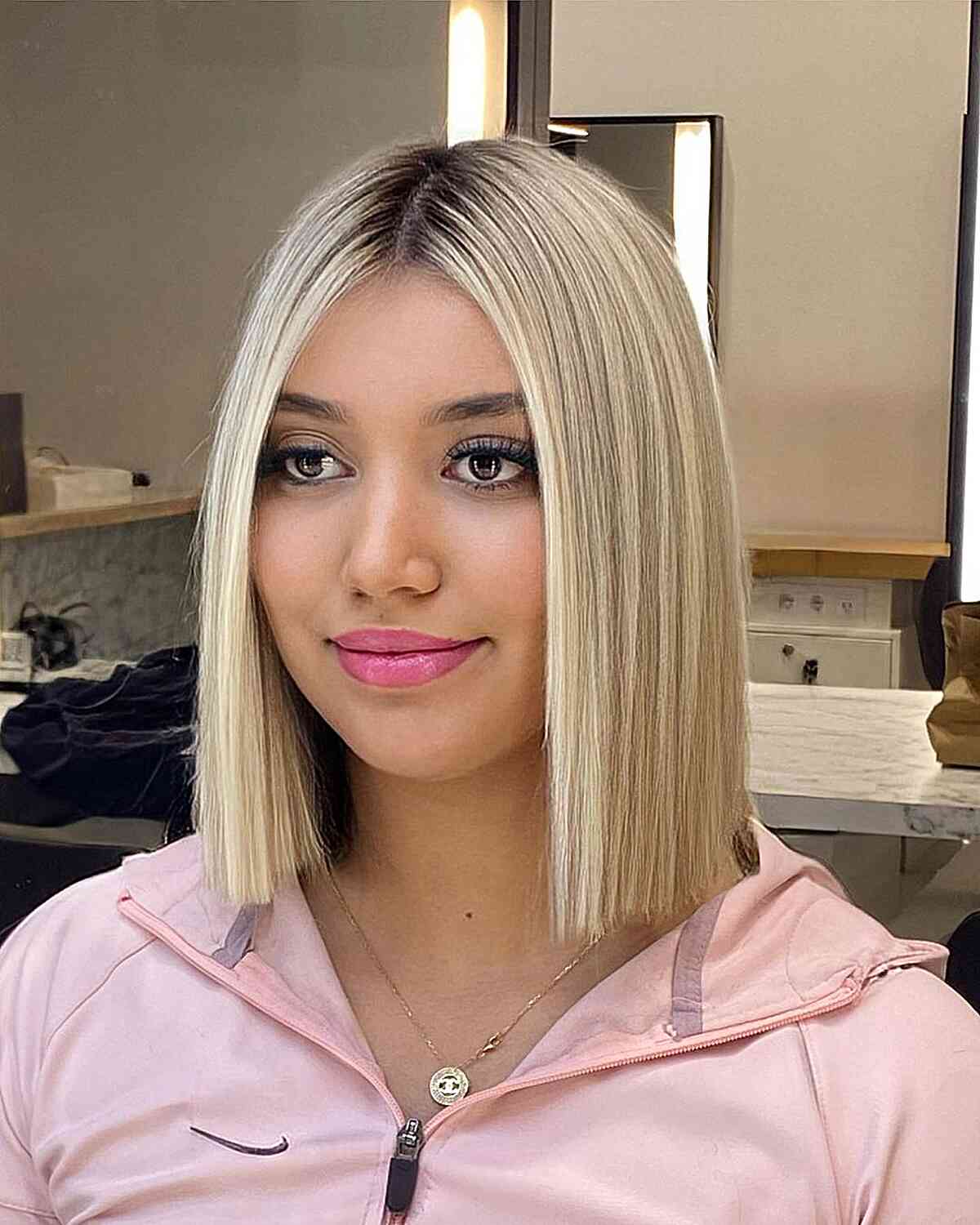 Rooted Slob Blunt Bob with a Middle Part for women with blonde hair
