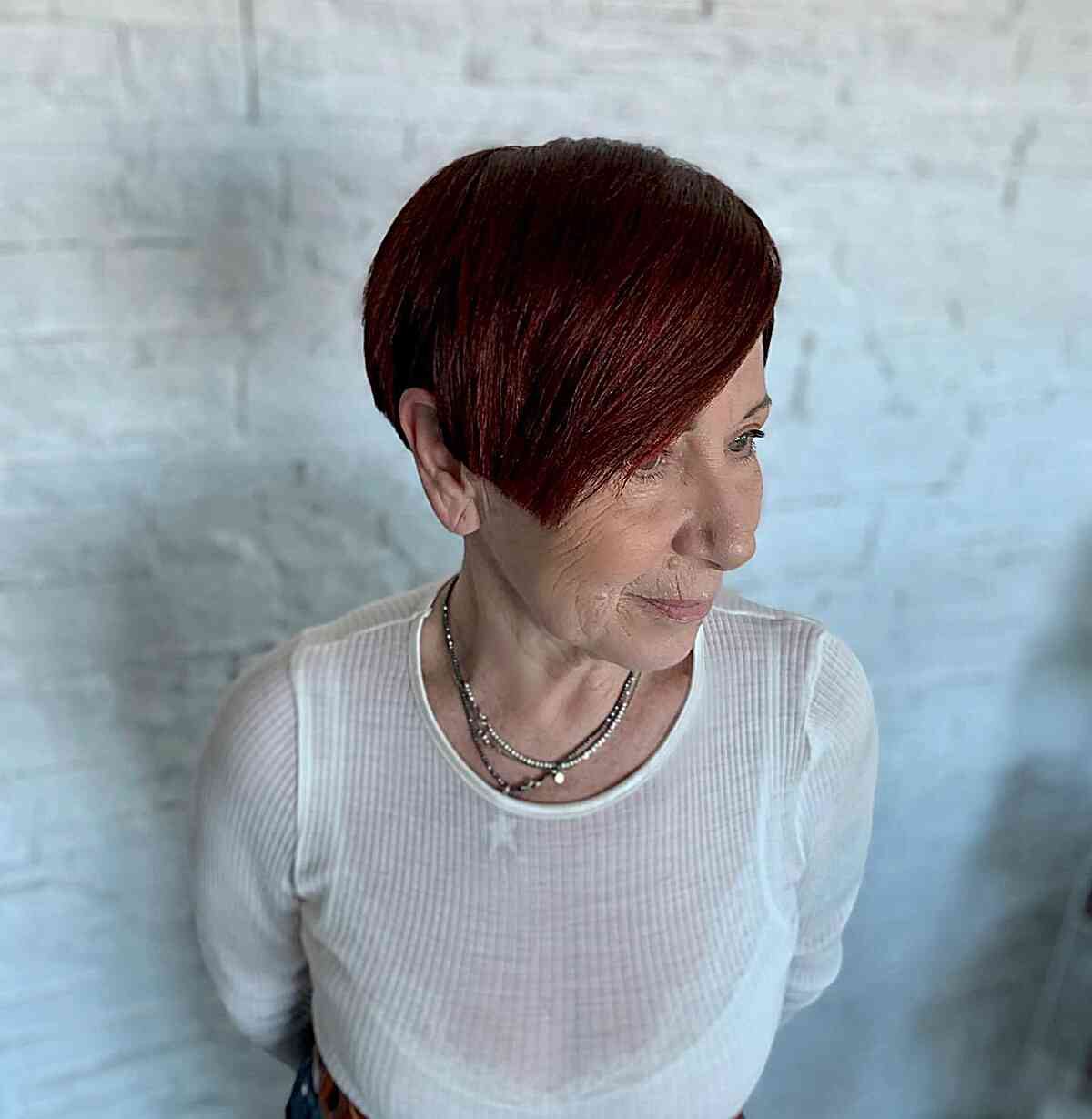 Ruby Red Long Pixie Cut with Extended Bangs for women aged 70