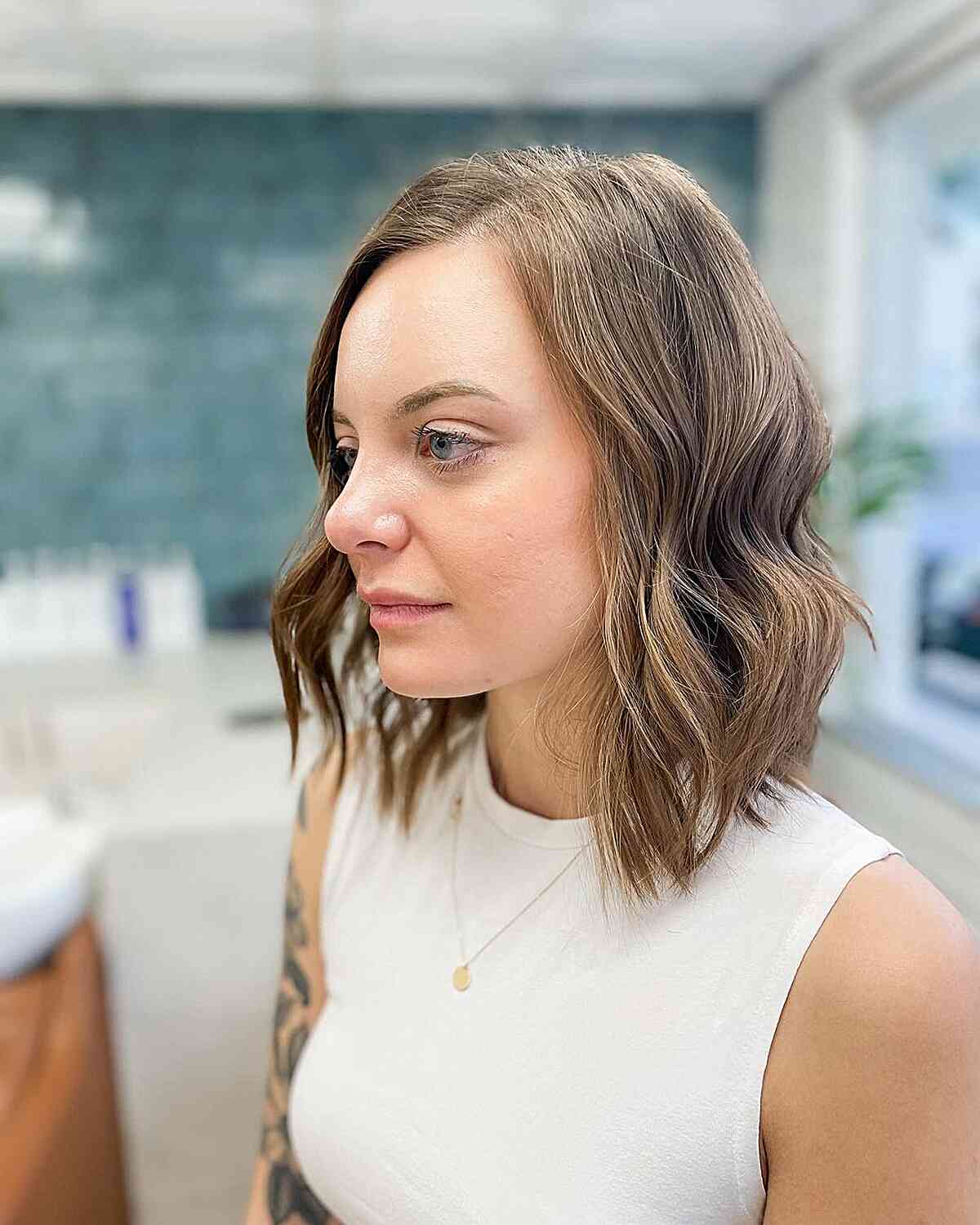 Shoulder length hair styled messily with a sandy brown ombre