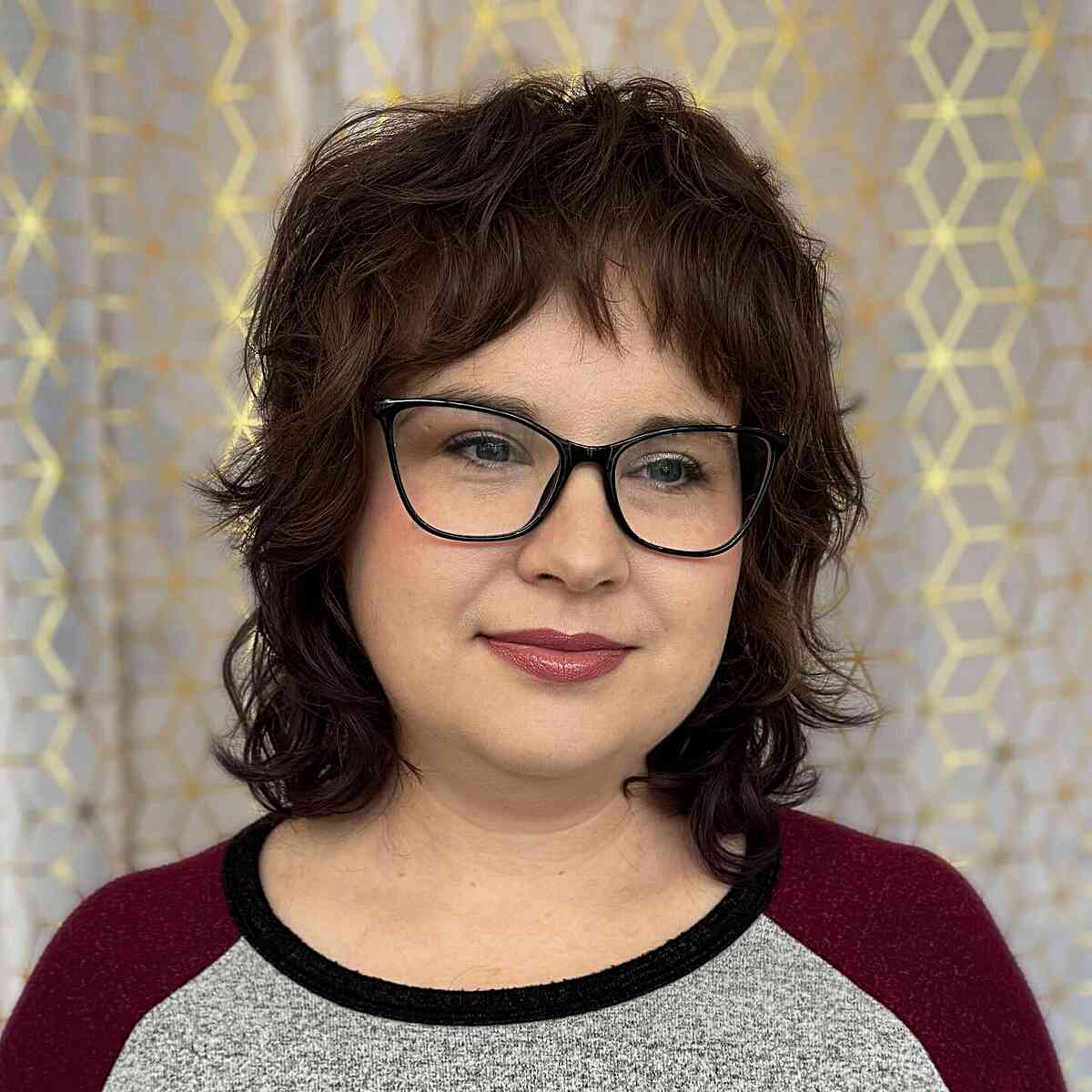 Shoulder-Length Shaggy Mullet Haircut Featuring Baby Bangs for Women Over 40 with Glasses
