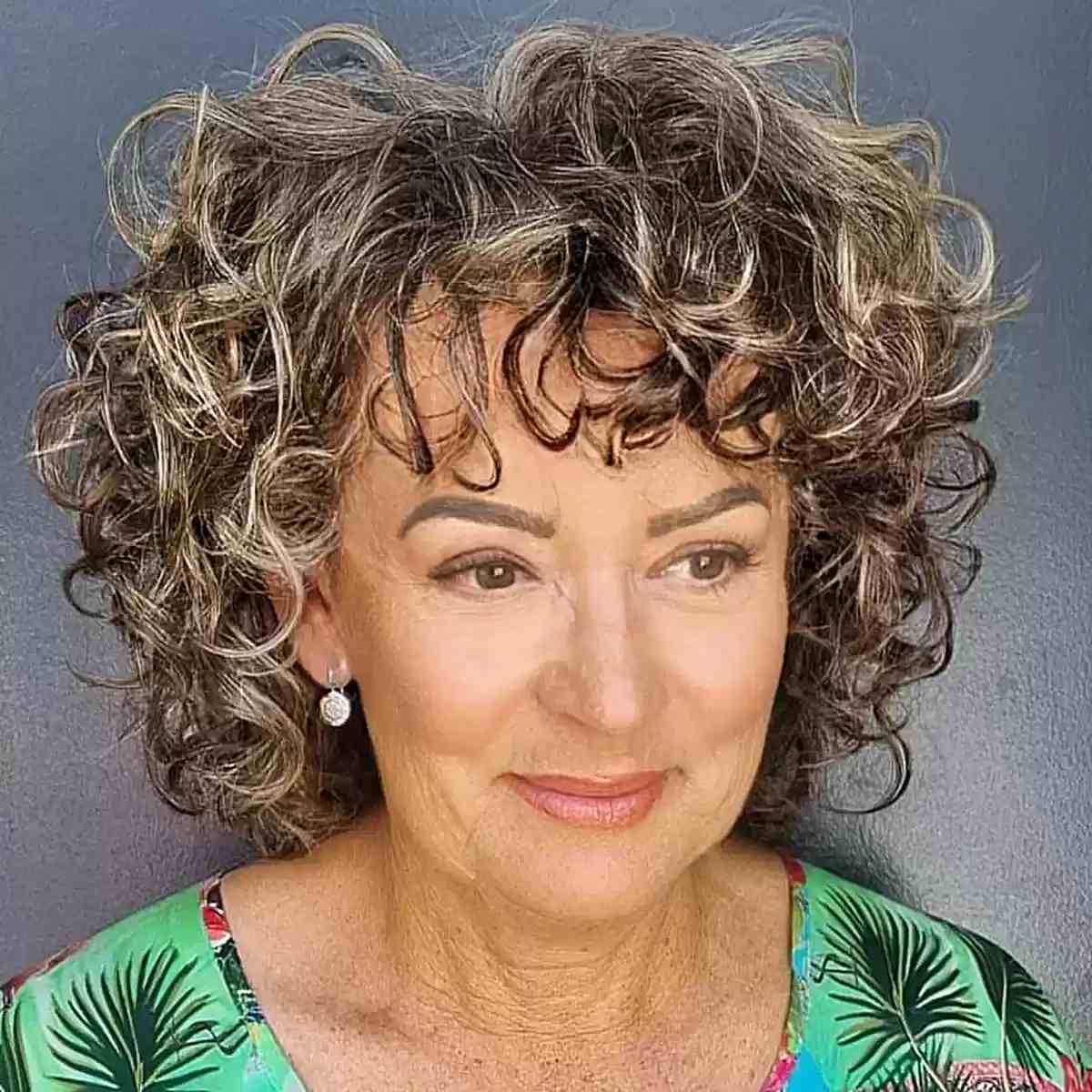 Shoulder-Length Curly Bob with Textured Bangs on Women Aged 50