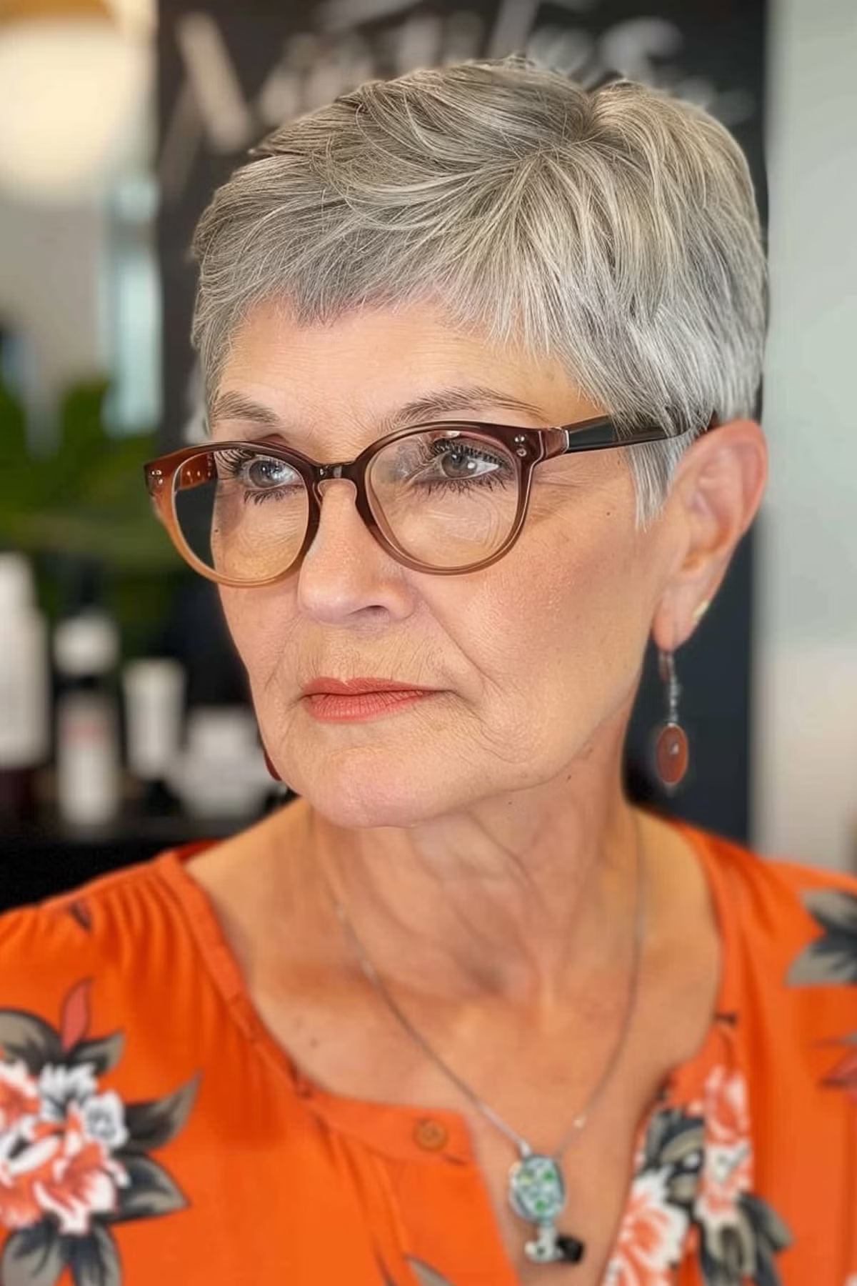 Silver pixie hairstyle for women with oversized glasses