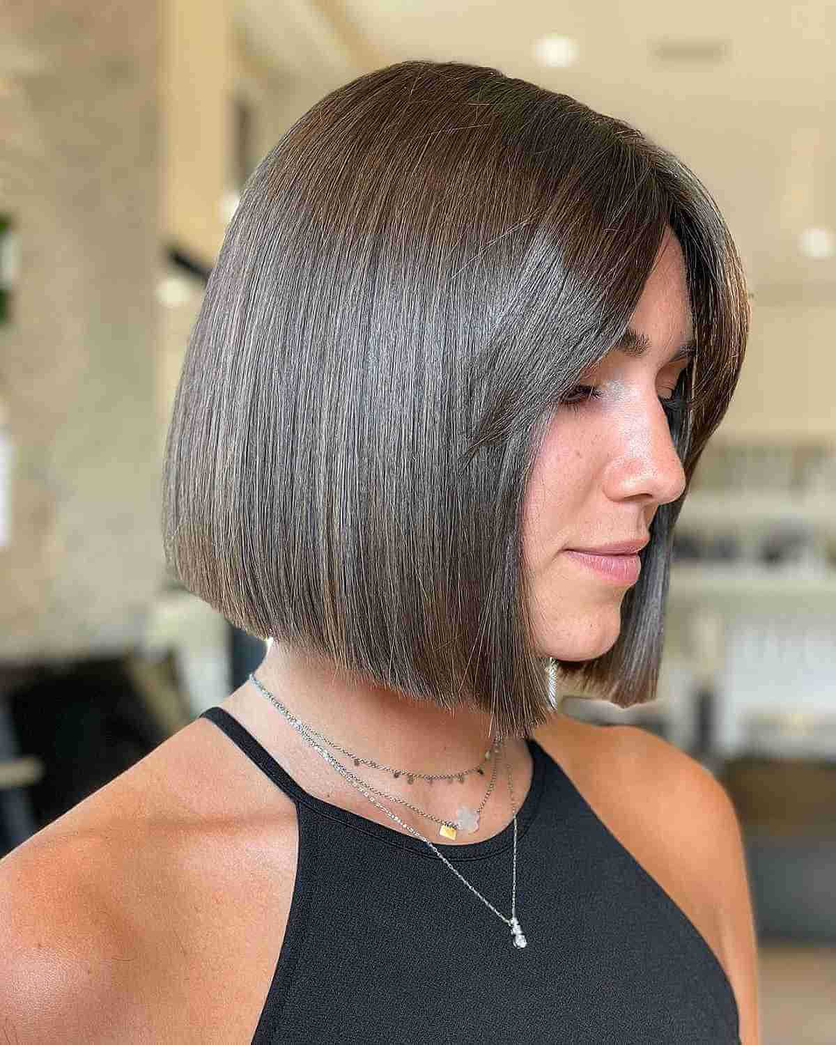 Sleek Bob Hairstyle Featuring Center-Part Bangs