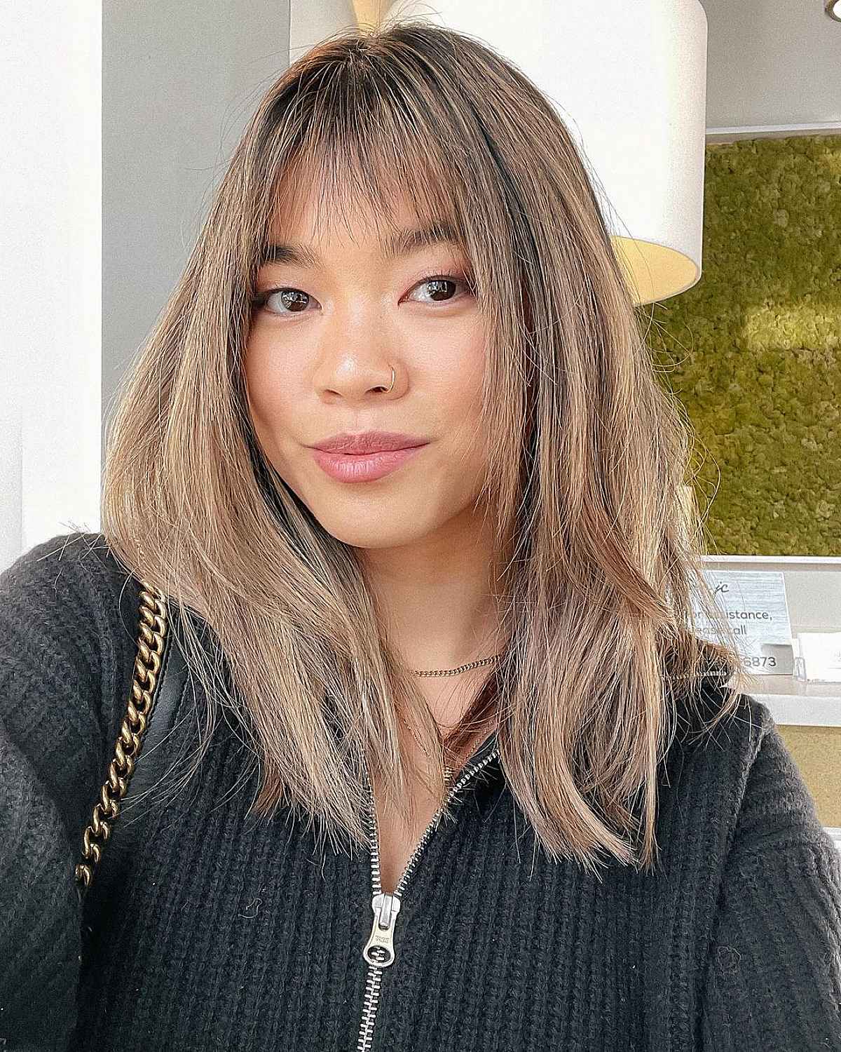 Sleek Layered Hairstyle with Delicate Bangs