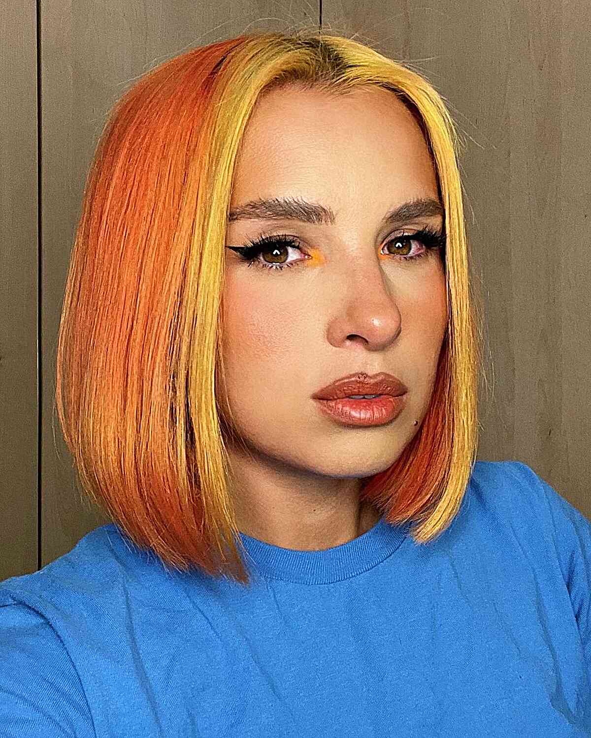 Above the Shoulder Sleek Tangerine Bob with a Golden Money Piece