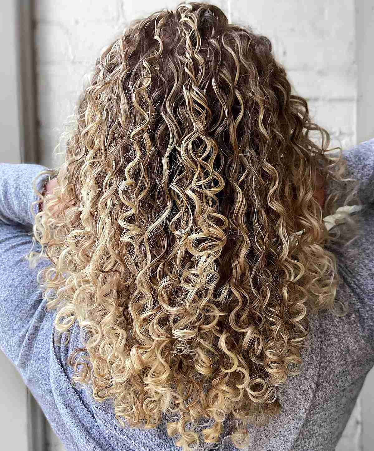 Soft Blonde Balayage for Mid Back-Length Layered Curly Hair