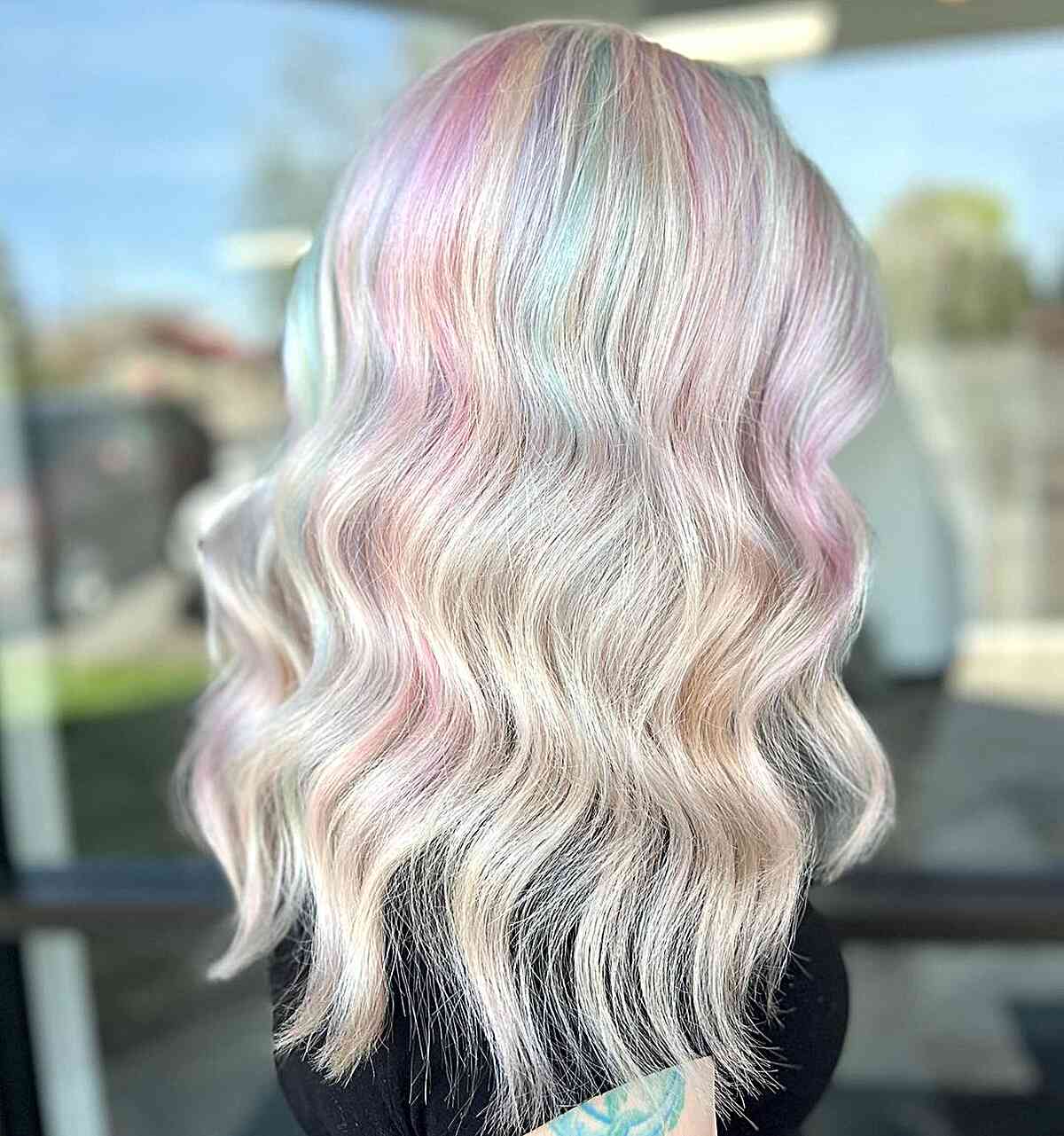 Soft Pastel Rainbow Hair Color for girls with medium-length wavy hair