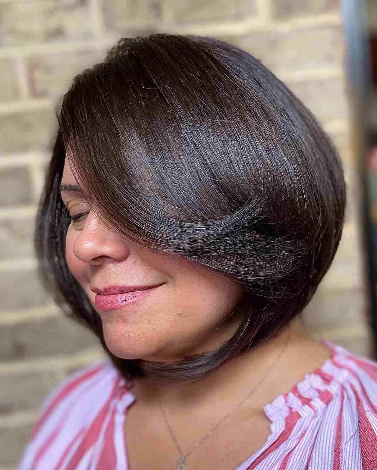 Sophisticated A-Line Bob with Extended Bangs for a Lady in Her 40s
