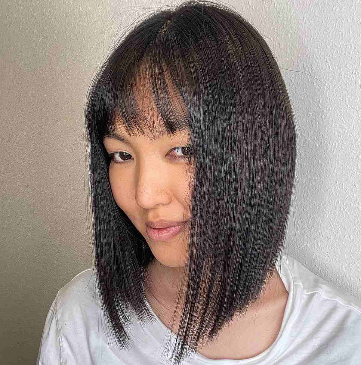 Sophisticated Collarbone Bob with Subtle Bangs for Thinning Hair