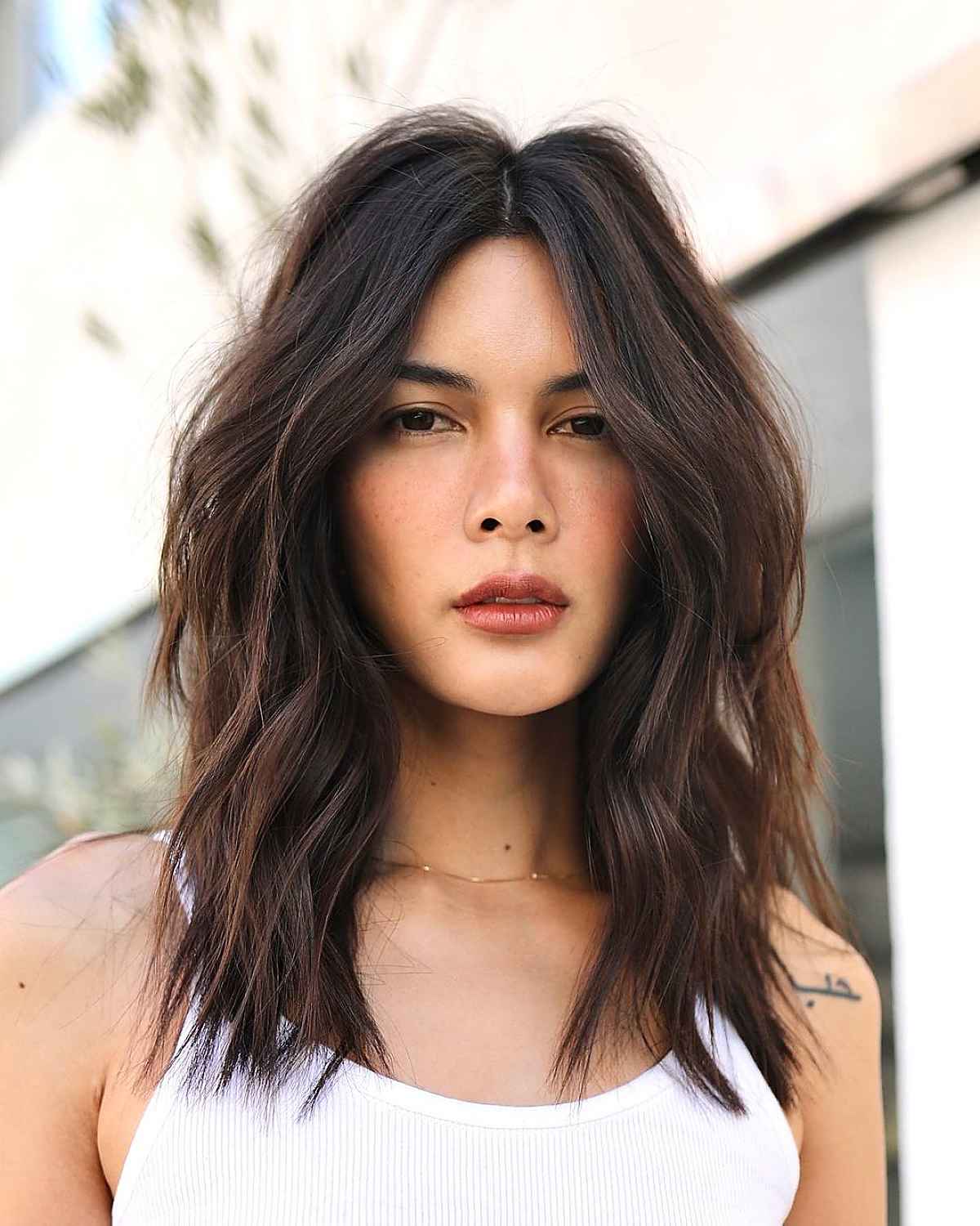 Sophisticated middle-parted textured lob haircut