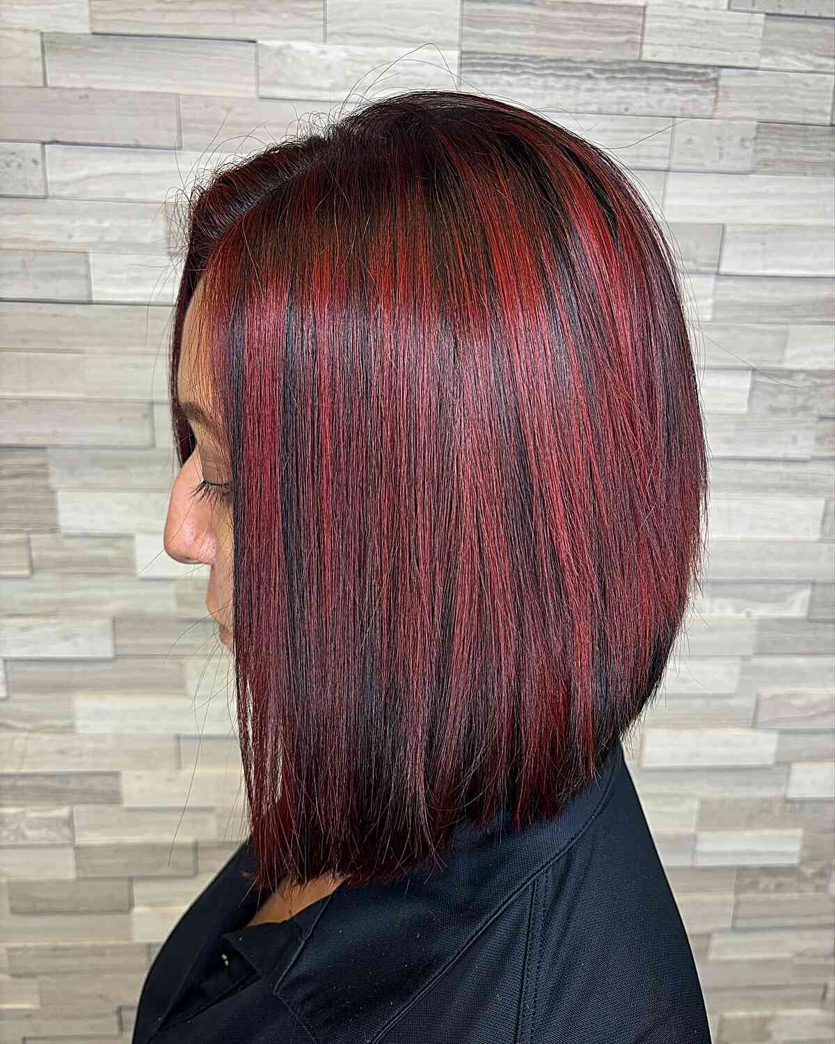 Straight dark brown hair featuring vibrant red highlights