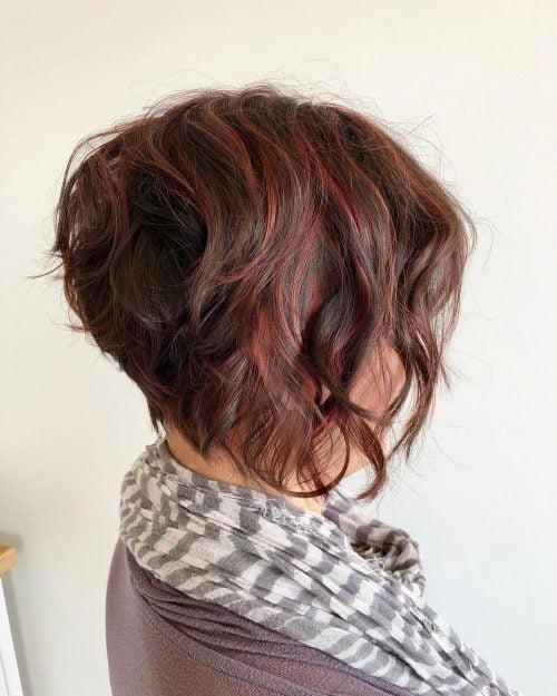 Stunning red highlights on curly brown hair