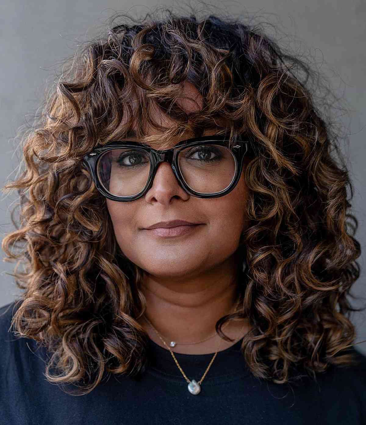 Stunning Thick Dark Curls with Subtle Highlights for 40-Year-Olds