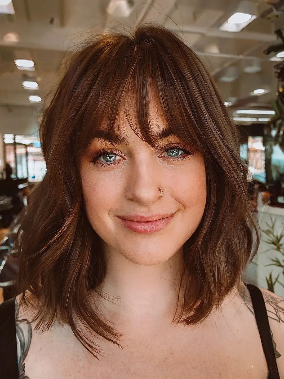 Long layered bob hairstyle featuring bangs