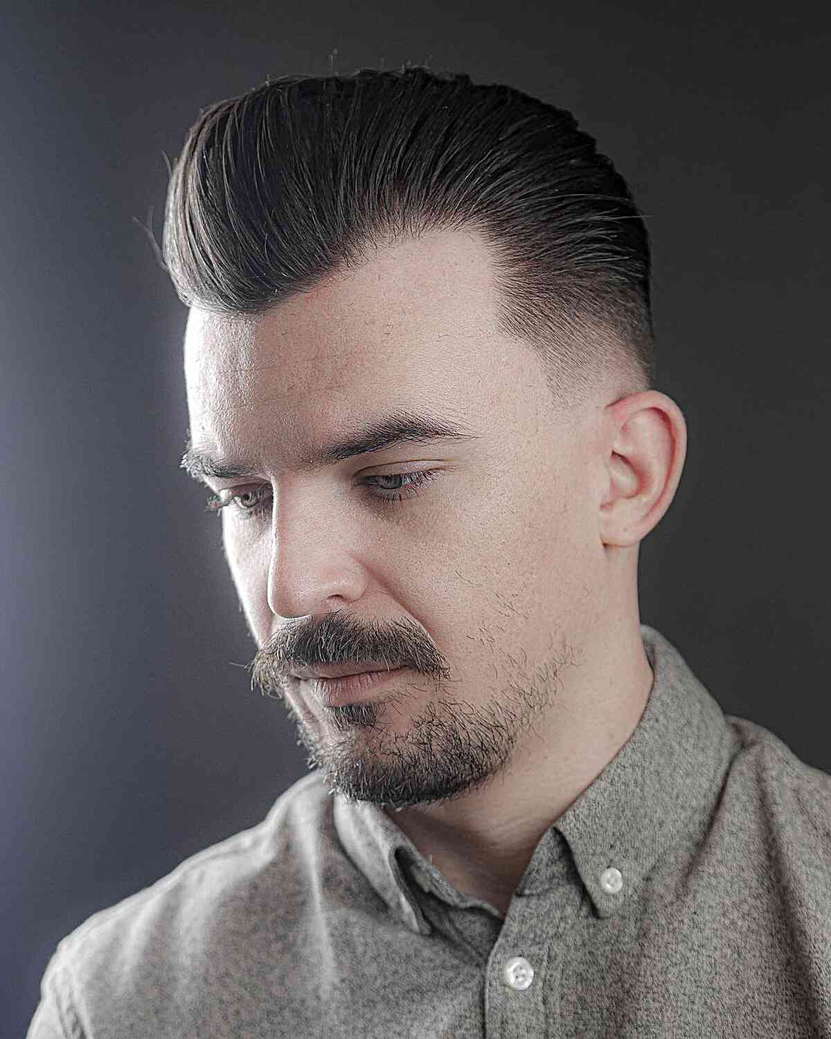 Stylish Brushed Back Pomp with Tapered Sides for Men with Widow's Peak Hairline