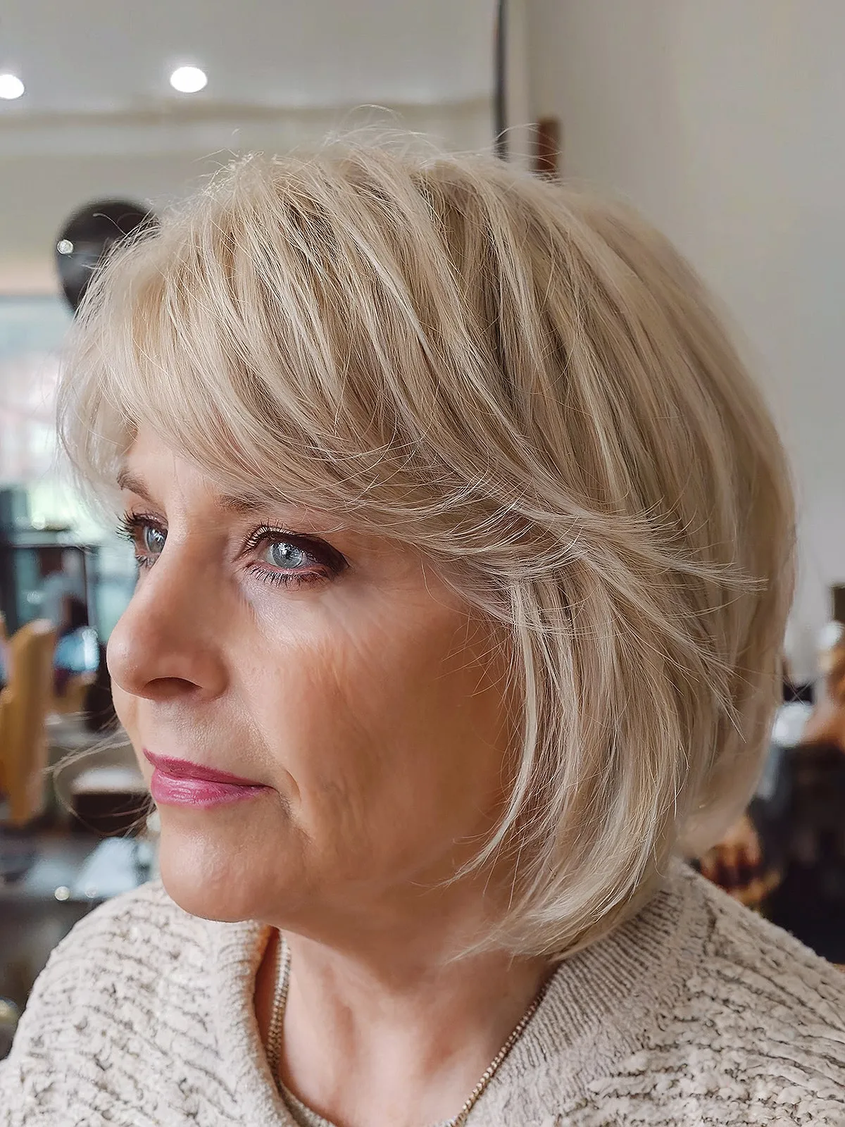 Chic Layered Bob with White Blend Regrowth and Bangs for Mature Women