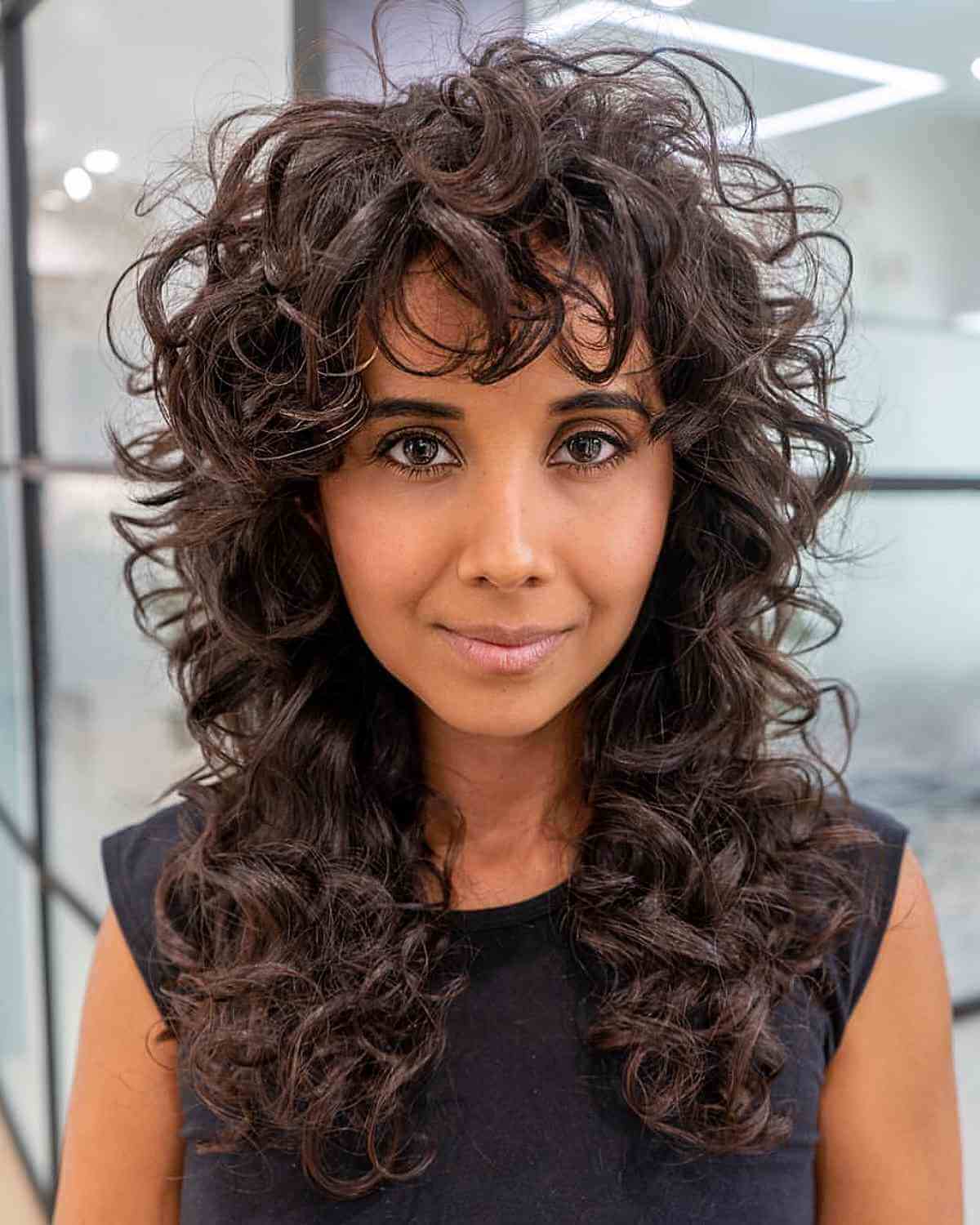 Stylish Long Curly Shag with Bangs for Women Over 40