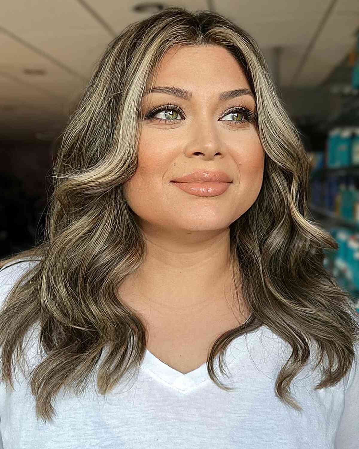 Stylish Medium Blonde Balayage with a Central Parting for Round Faces