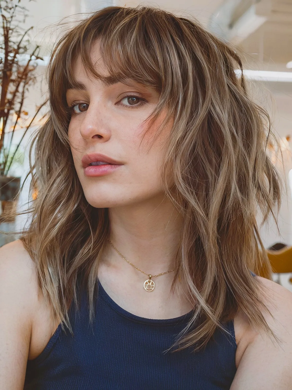 Stylish Medium Wolf Cut with Soft Waves and Feathered Bangs