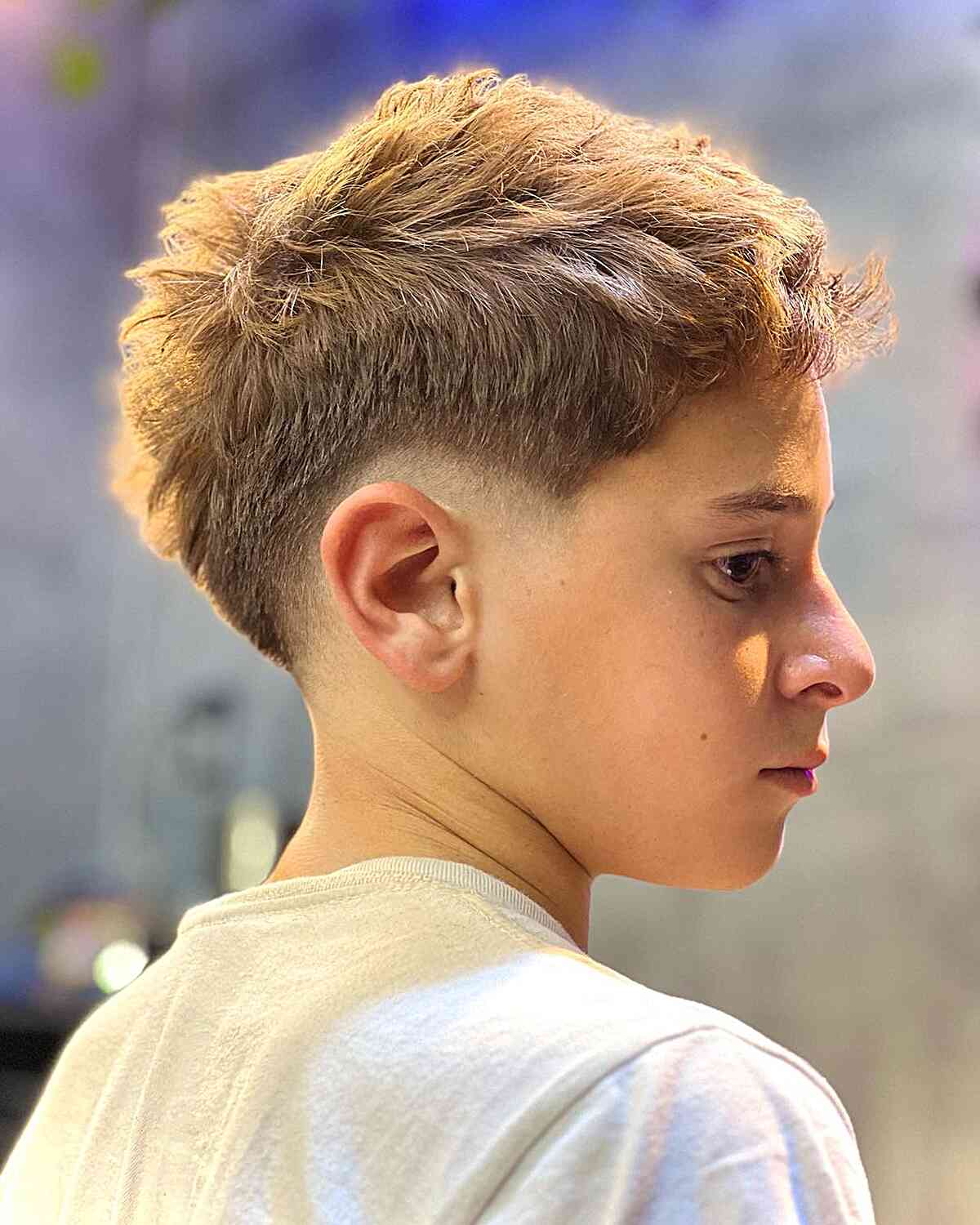 Stylish Messy Mid Drop Fade for Teen Guys with a fashion sense