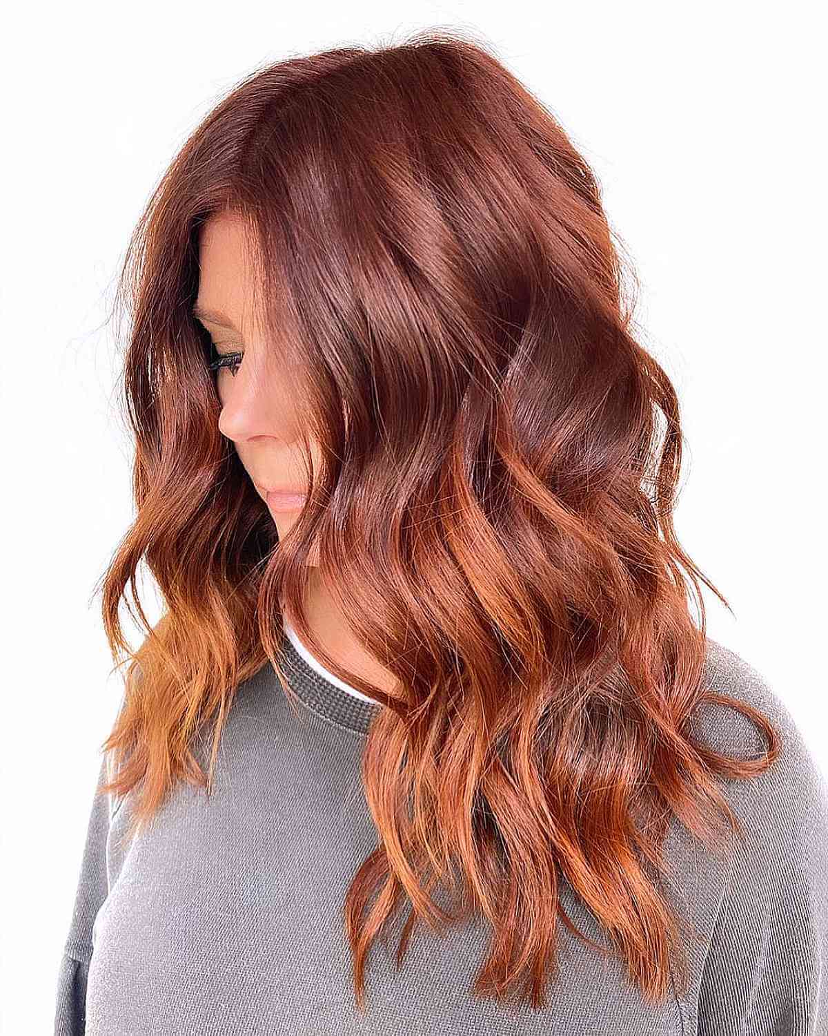 Stylish Mid-Back Copper Hair for Women Above 50 with Long Wavy Hair