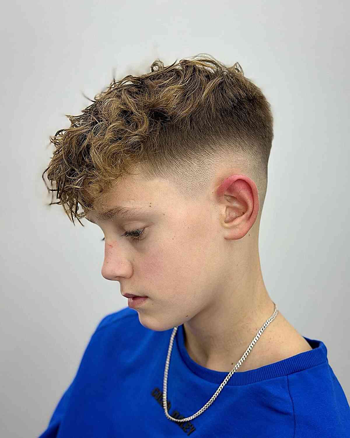 Stylish Mid Fade with a Lively, Curly Top for Boys