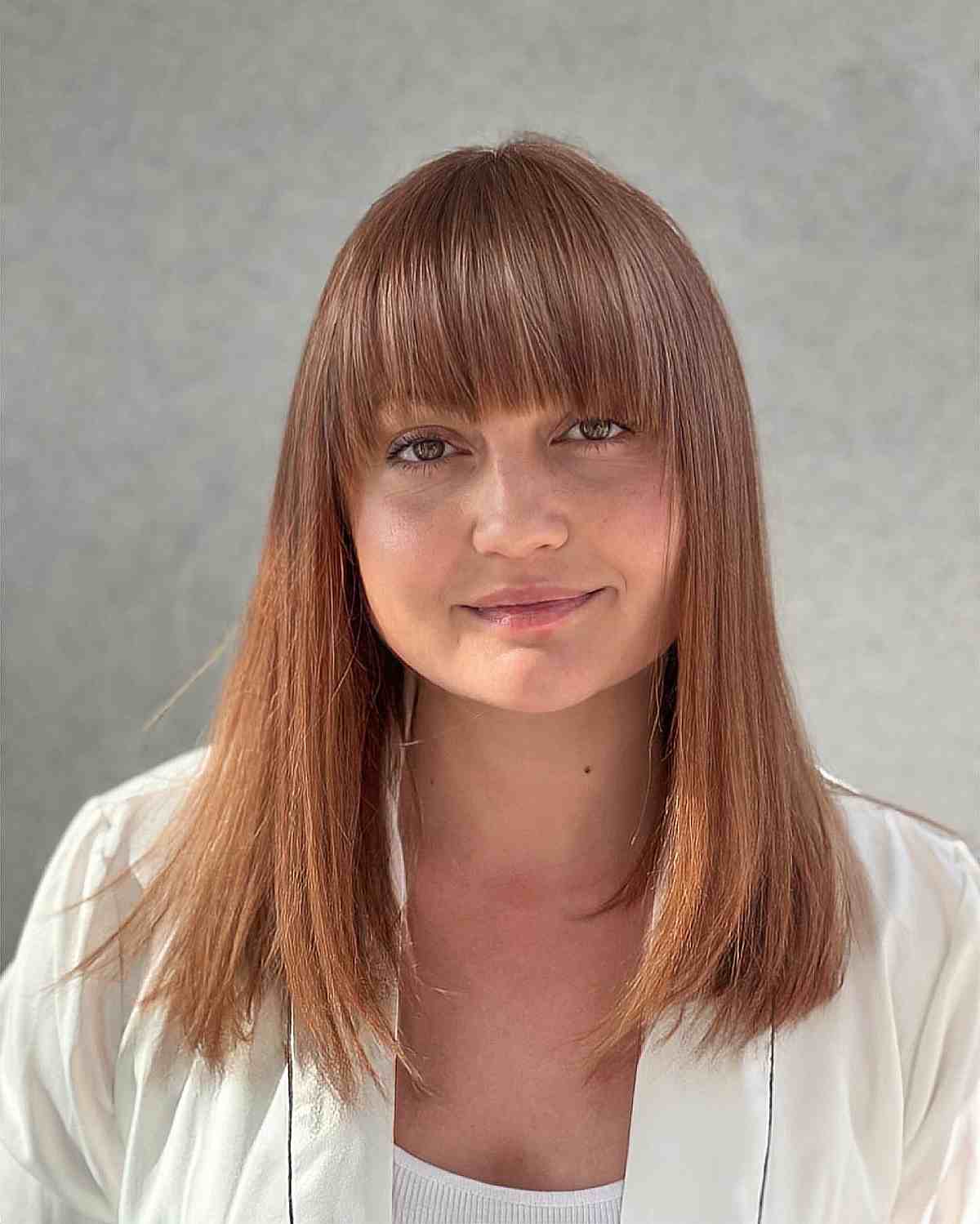 Stylish Mid-Length Straight Hair with Textured Ends and Full Fringe