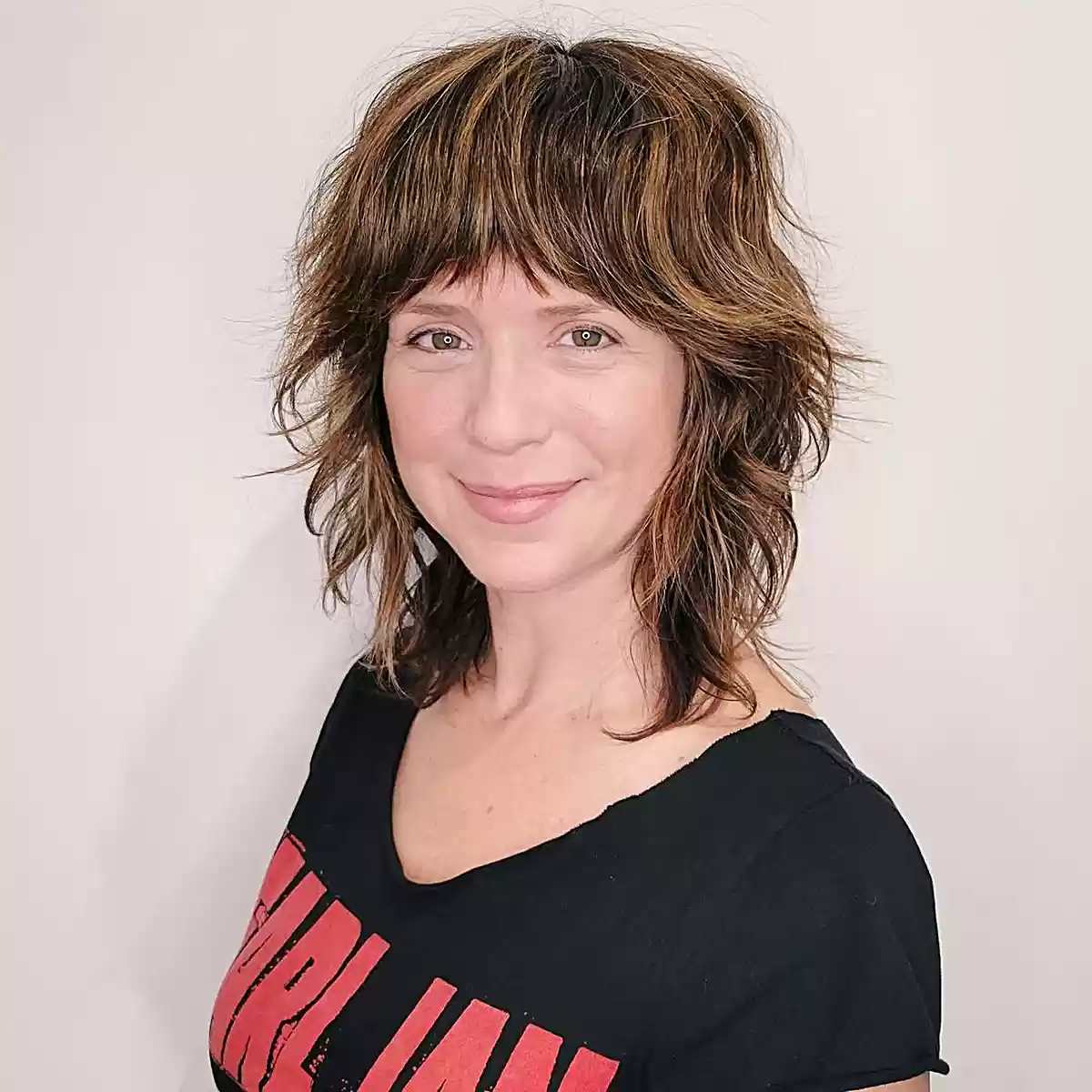 Stylish Mid-Length Shag with Textured Layers and Fringe for 40-Year-Old Women