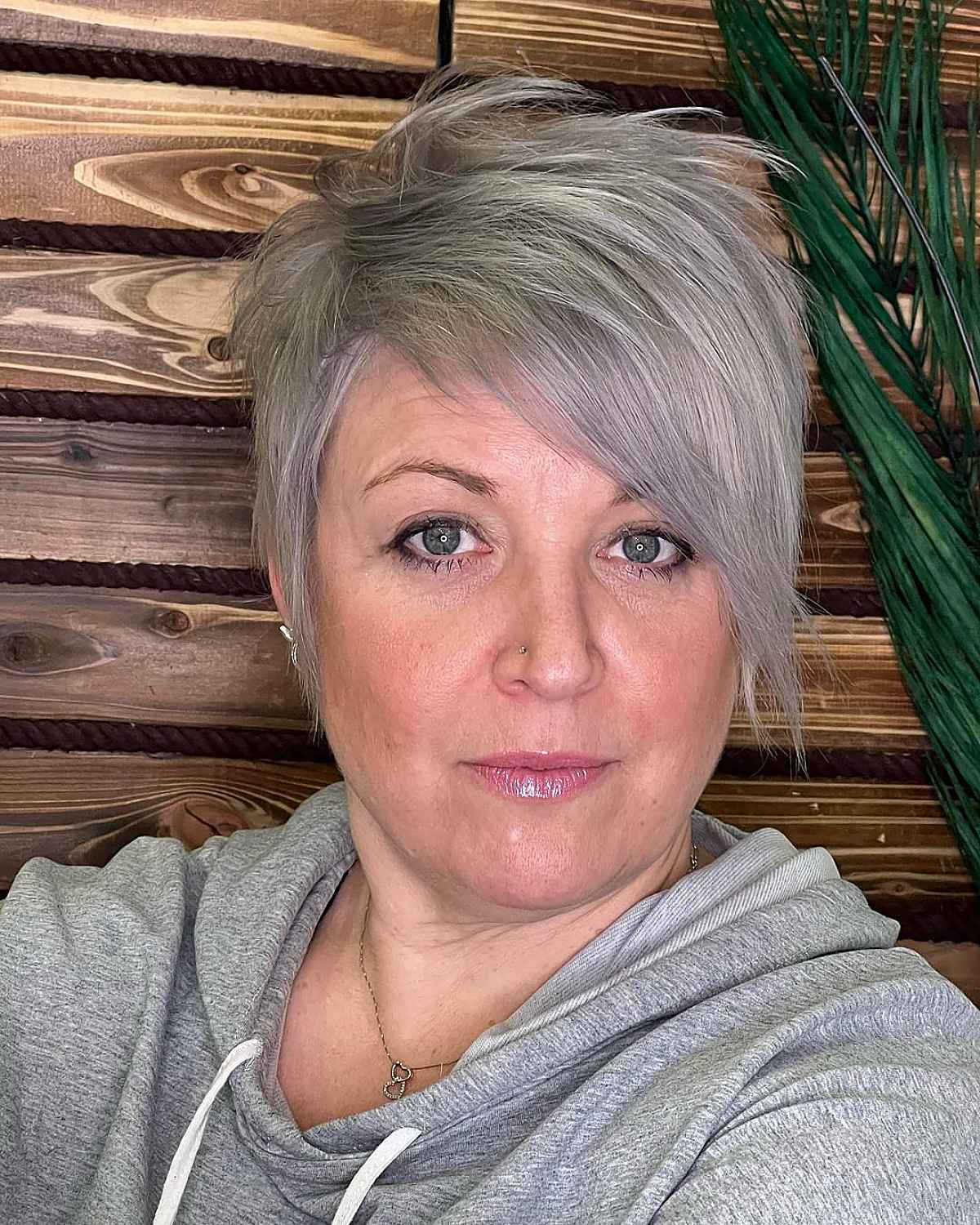 Stylish Pixie Cut with Extended Bangs for Women Over 50 with Thin Hair