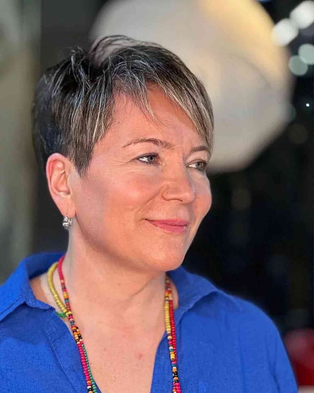 Stylish Pixie with Subtle Highlights for Older Women featuring a modern style and side bangs