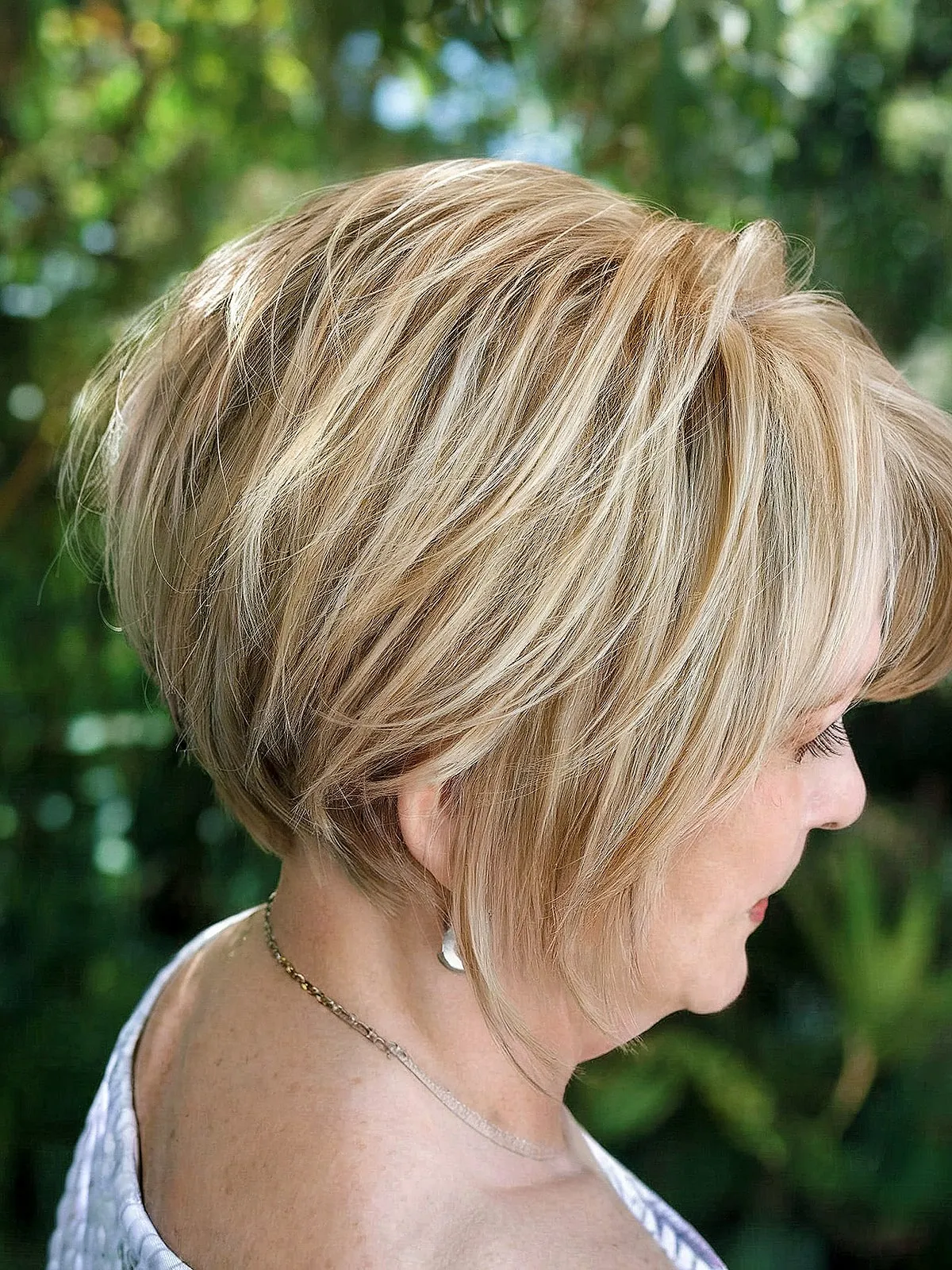 Stylishly Layered Stacked Bob Cut with blonde balayage and an undercut