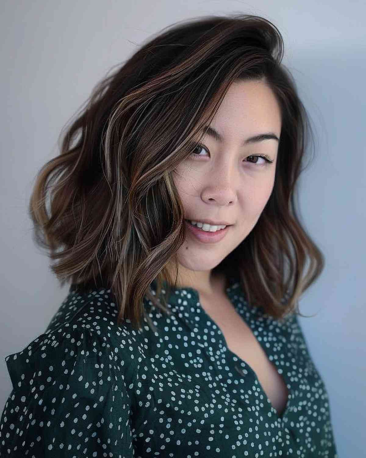 Medium Length Wavy Hair with Balayage Highlights on Woman