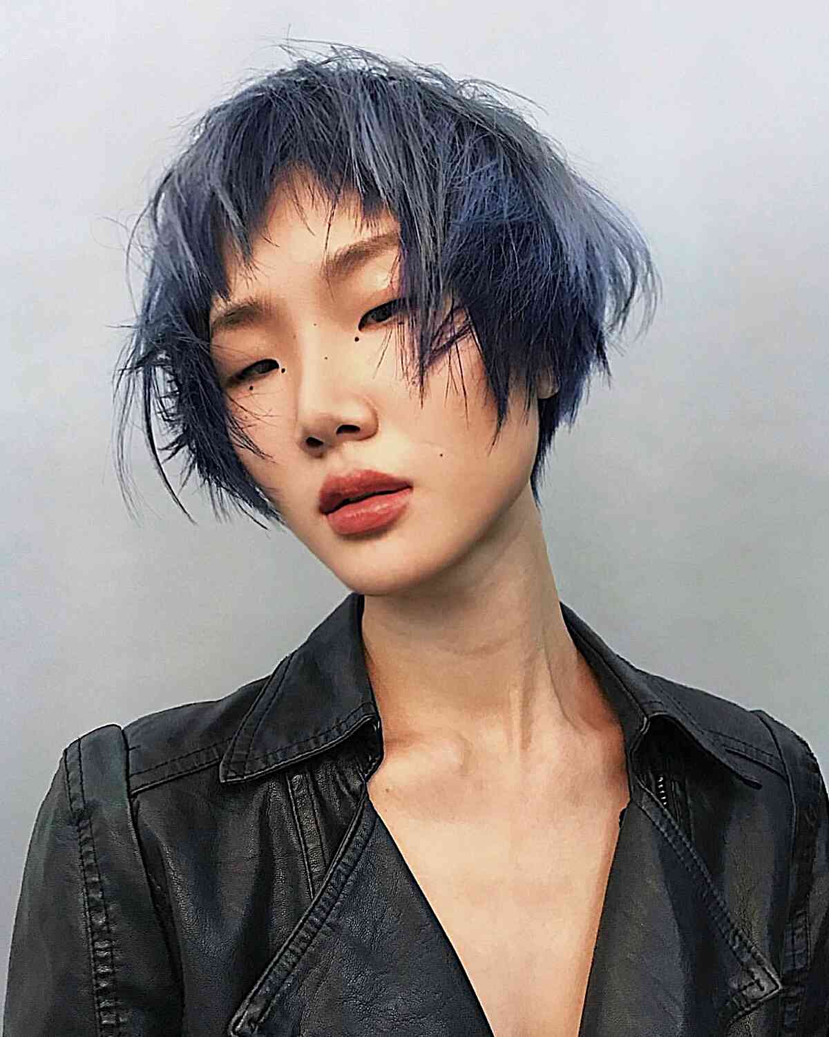 Textured Bixie with Razor-Sharp Layers on Jaw-Length Choppy Hair featuring Dark Blue Hue