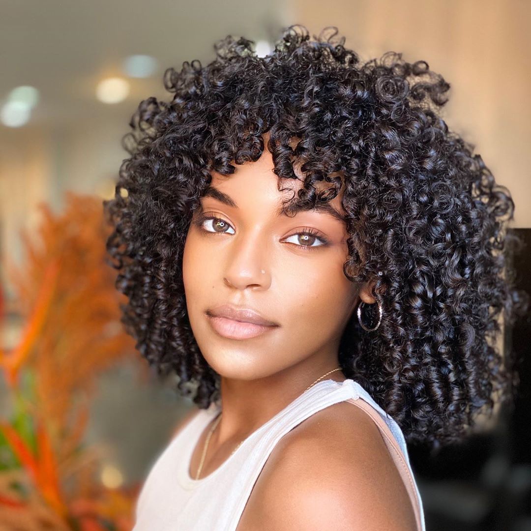 textured long curly bob with soft bangs