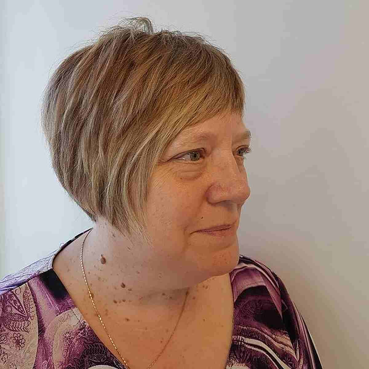 Textured Pixie Bob with Short Bangs for a 50-Year-Old Woman