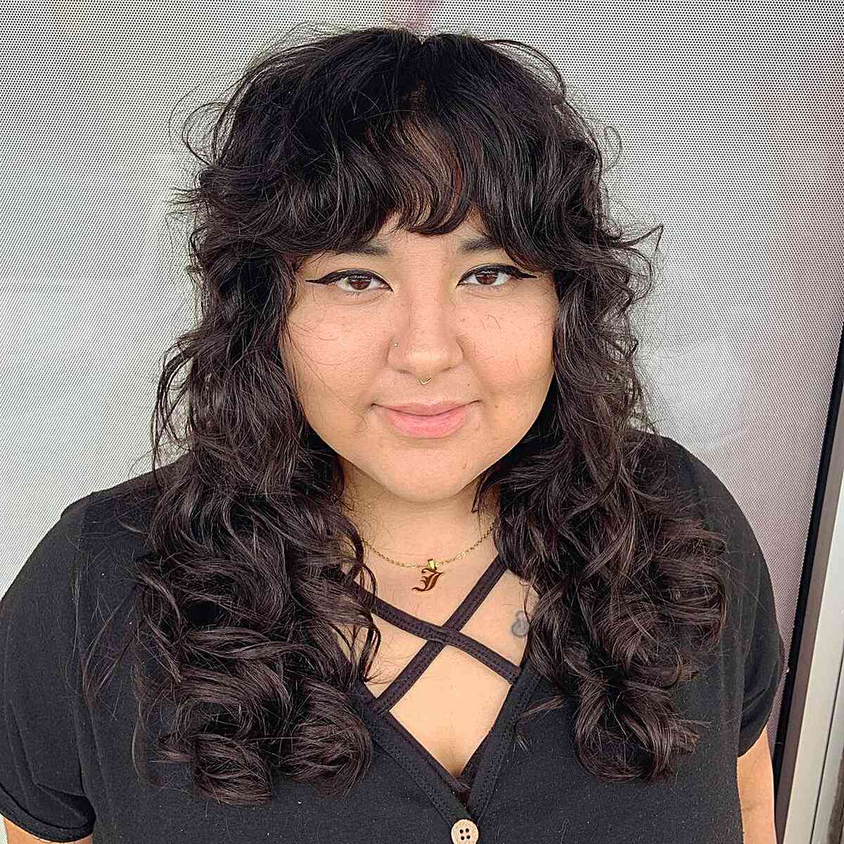 Mid-Length Textured Shag for Curly Hair with Bangs for Round Faces