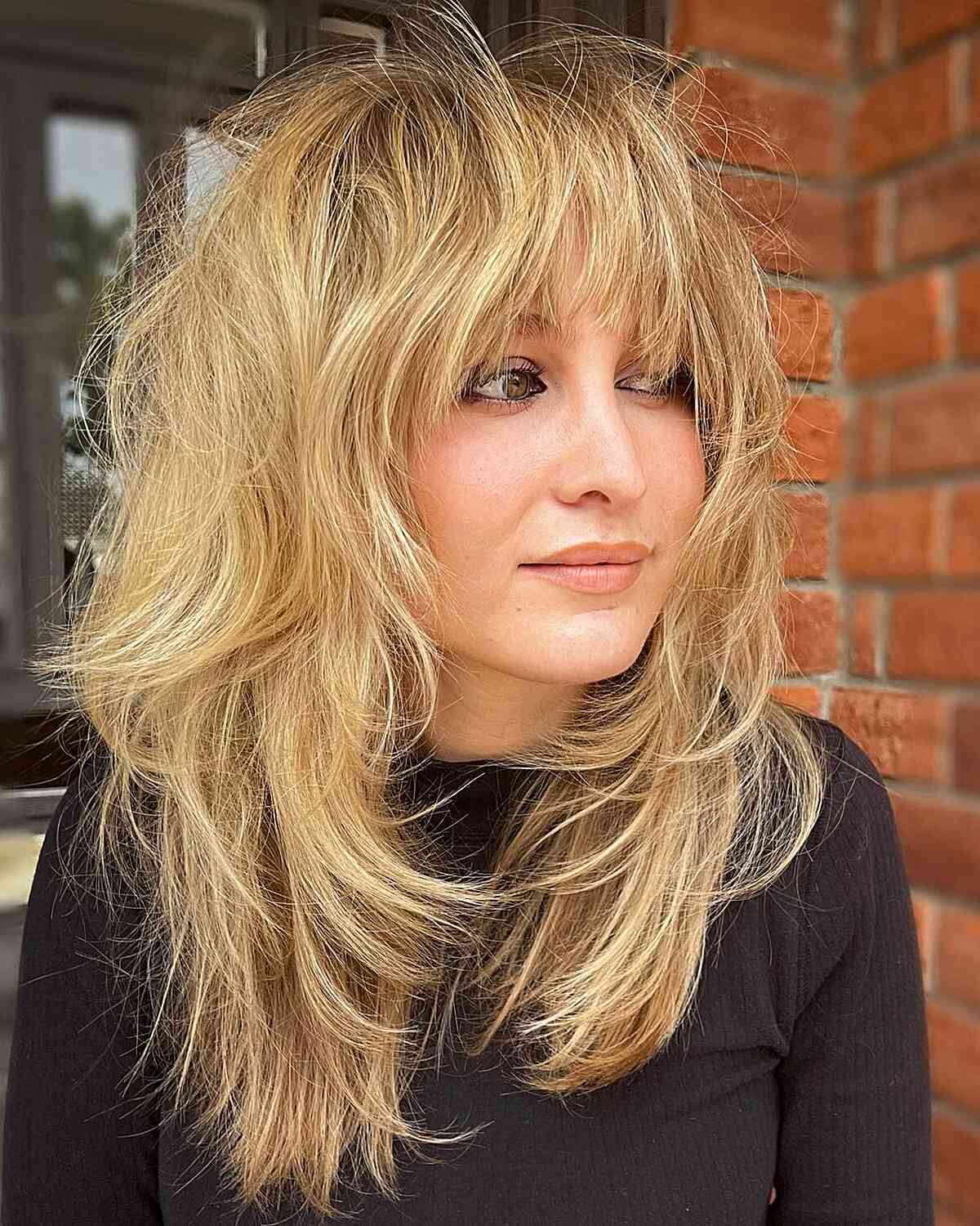 Medium-Length Textured Shaggy Butterfly Cut with Bangs for ladies with layered hair
