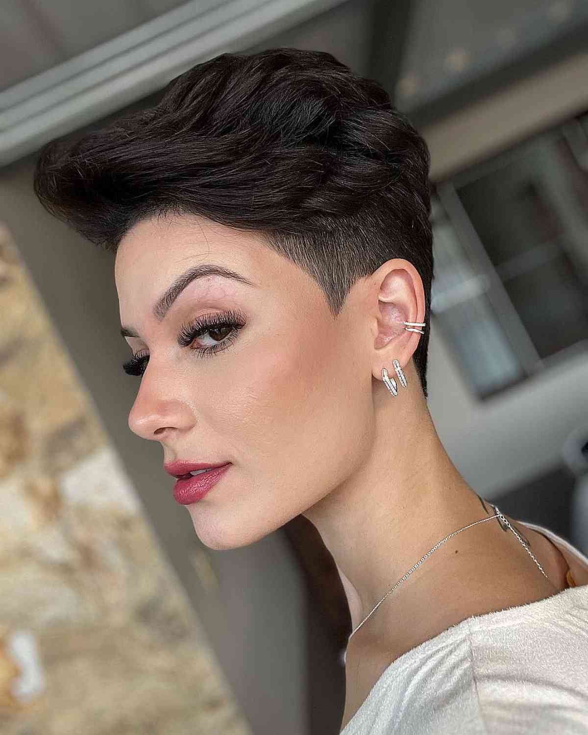 gender neutral hair featuring a textured undercut and lush volume on top