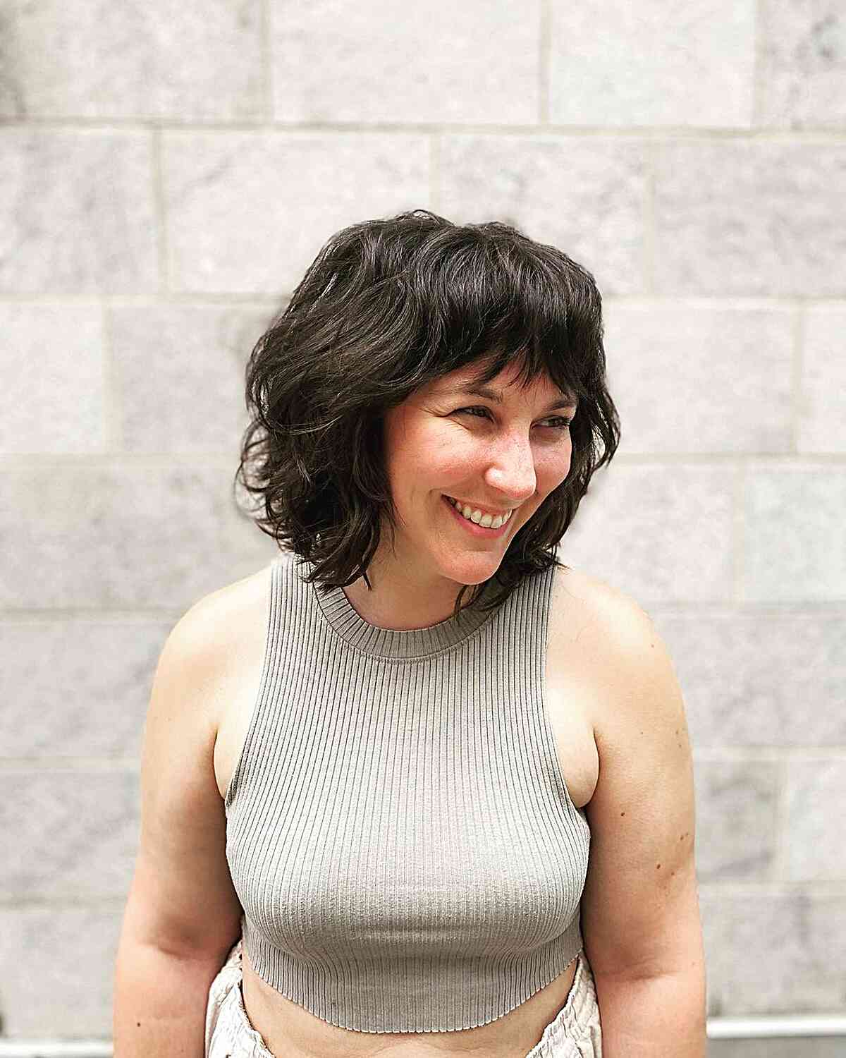 Neck-Grazing Layered Bob with Textured Waves and Fringe
