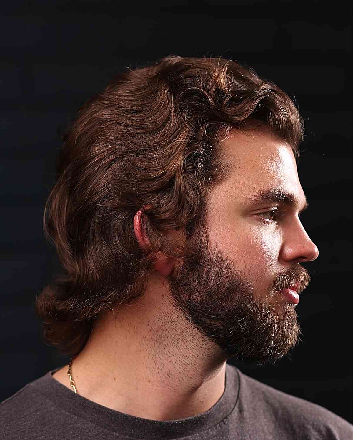 Textured Wavy Mid-Length Haircut for Men featuring a beard and mustache