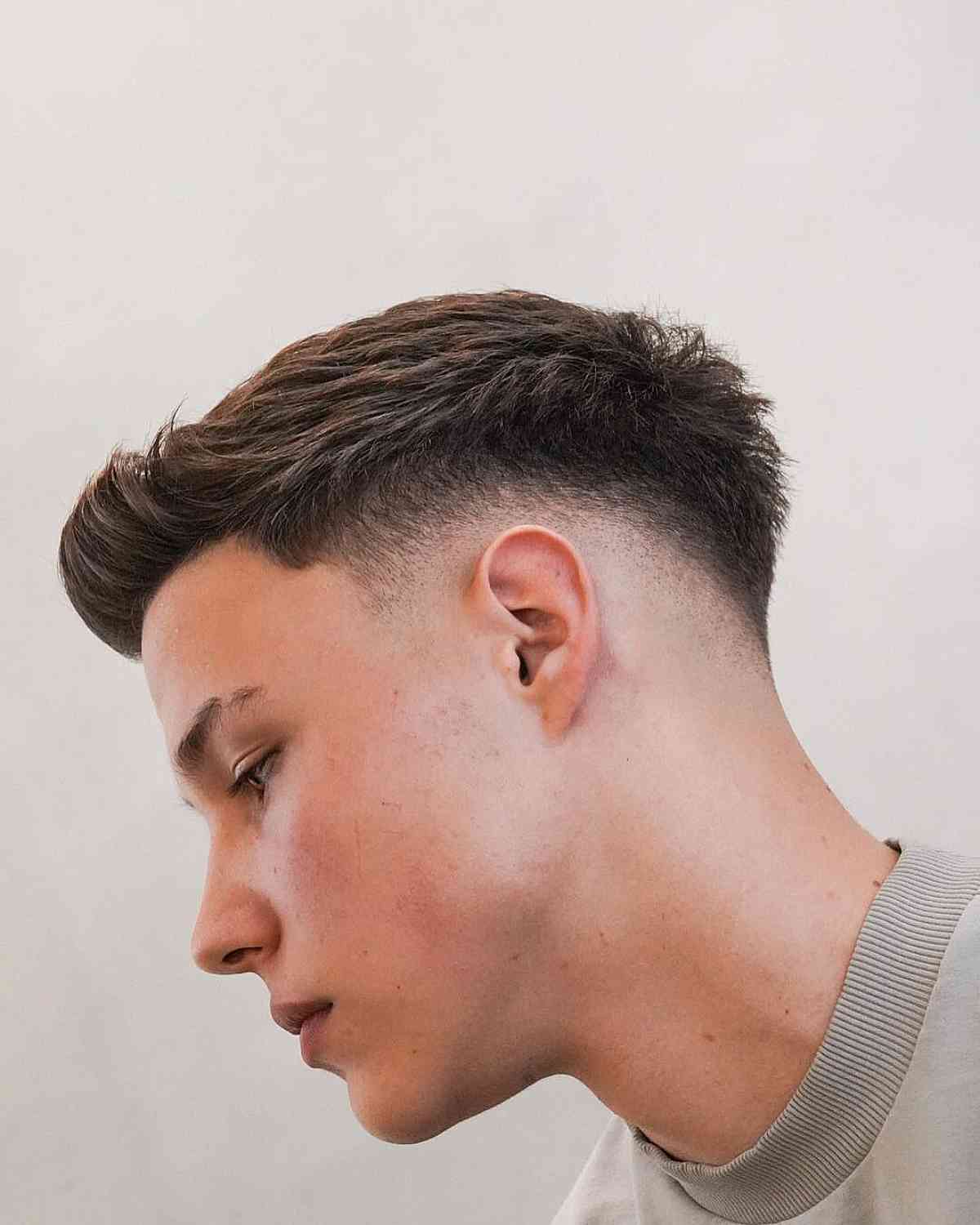 Low bald fade featuring a quiff